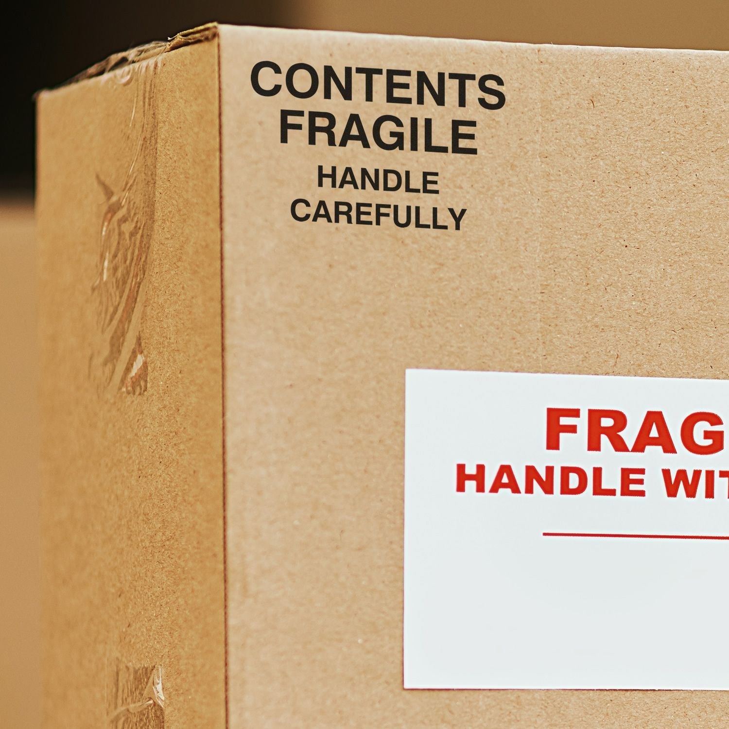 MaxLight XL2-5050 Custom Pre-Inked Business Stamp 2 x 2 used on a cardboard box labeled FRAGILE HANDLE WITH CARE.