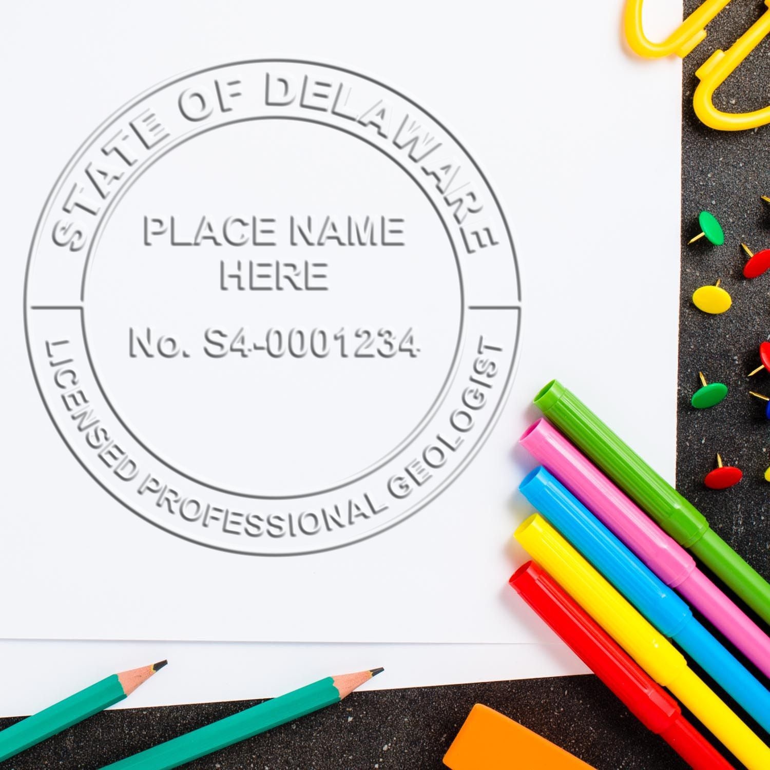 An in use photo of the Delaware Geologist Desk Seal showing a sample imprint on a cardstock