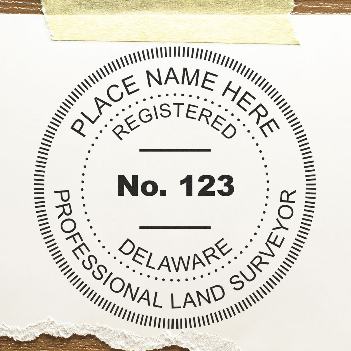 A lifestyle photo showing a stamped image of the Slim Pre-Inked Delaware Land Surveyor Seal Stamp on a piece of paper