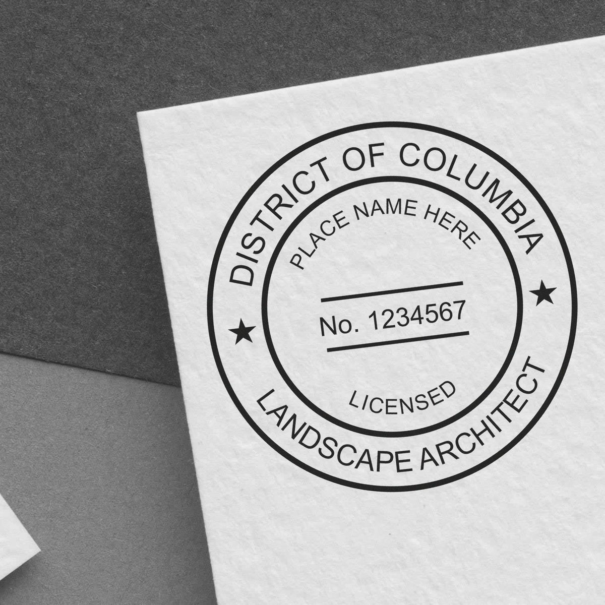 This paper is stamped with a sample imprint of the Slim Pre-Inked District of Columbia Landscape Architect Seal Stamp, signifying its quality and reliability.