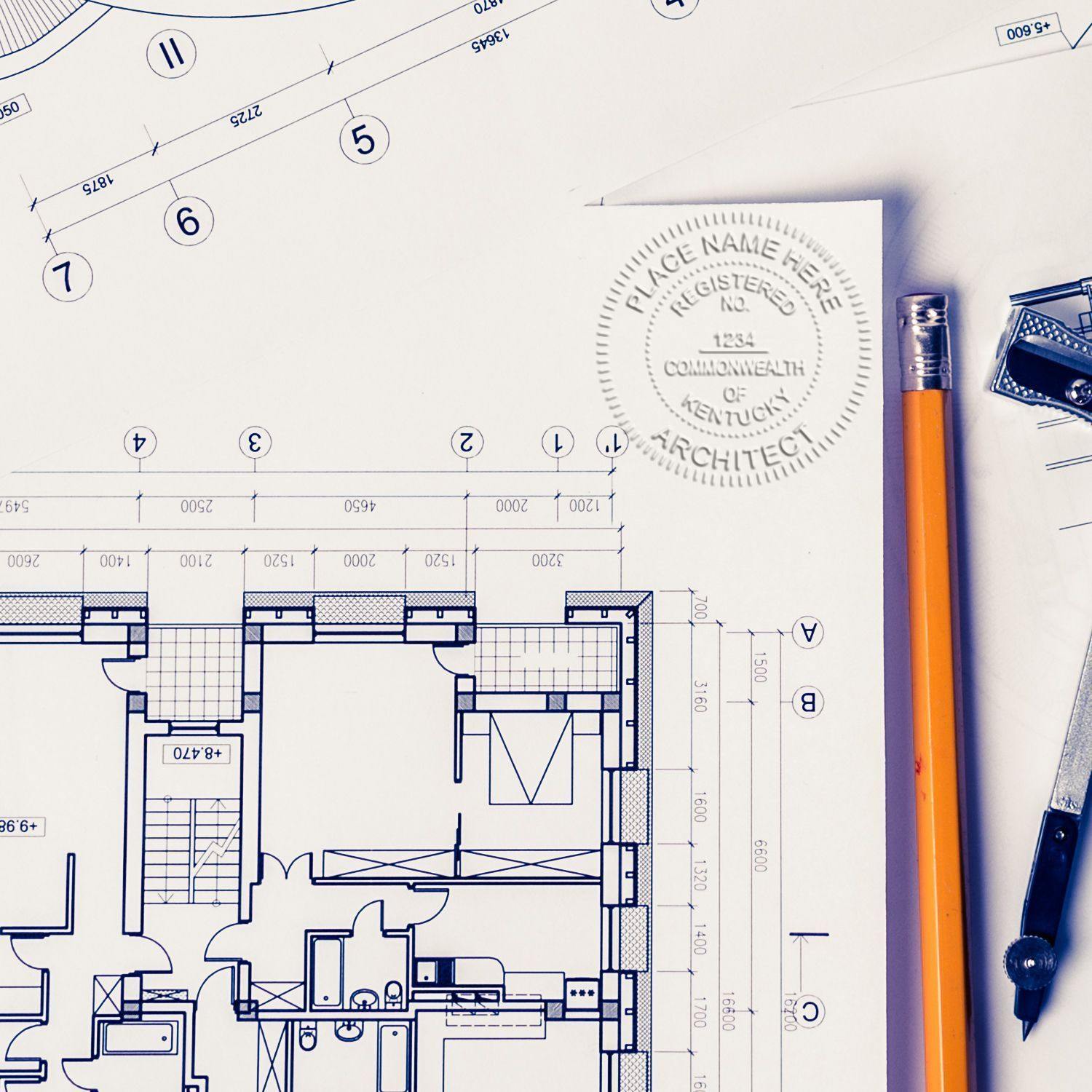 Architect Blue Seal Handheld Embosser in use on architectural blueprints, with a pencil and drafting tools nearby.