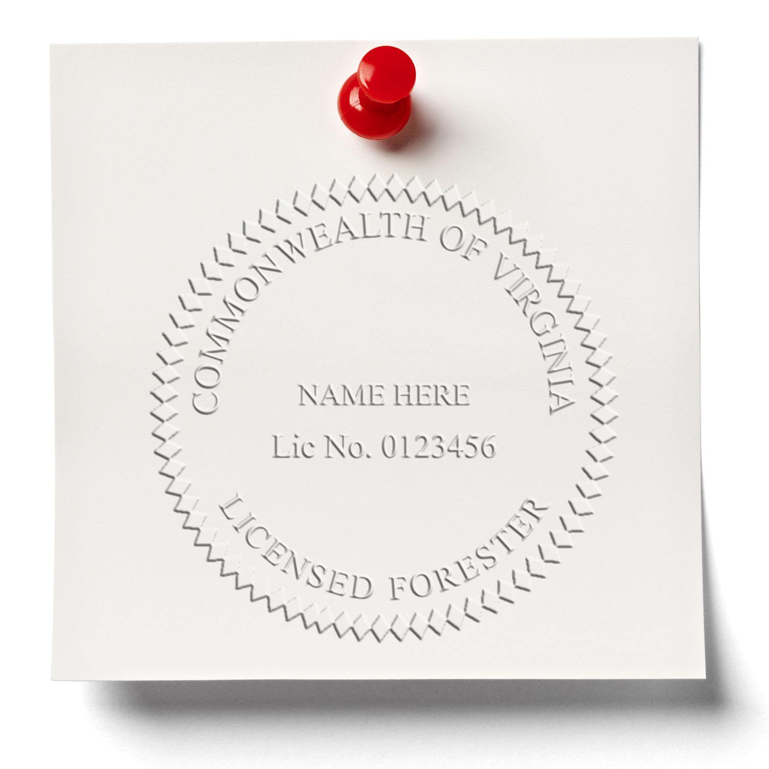 Forester Black Gift Seal Embosser imprint on white paper pinned with a red pushpin, displaying 'Commonwealth of Virginia Licensed Forester'.