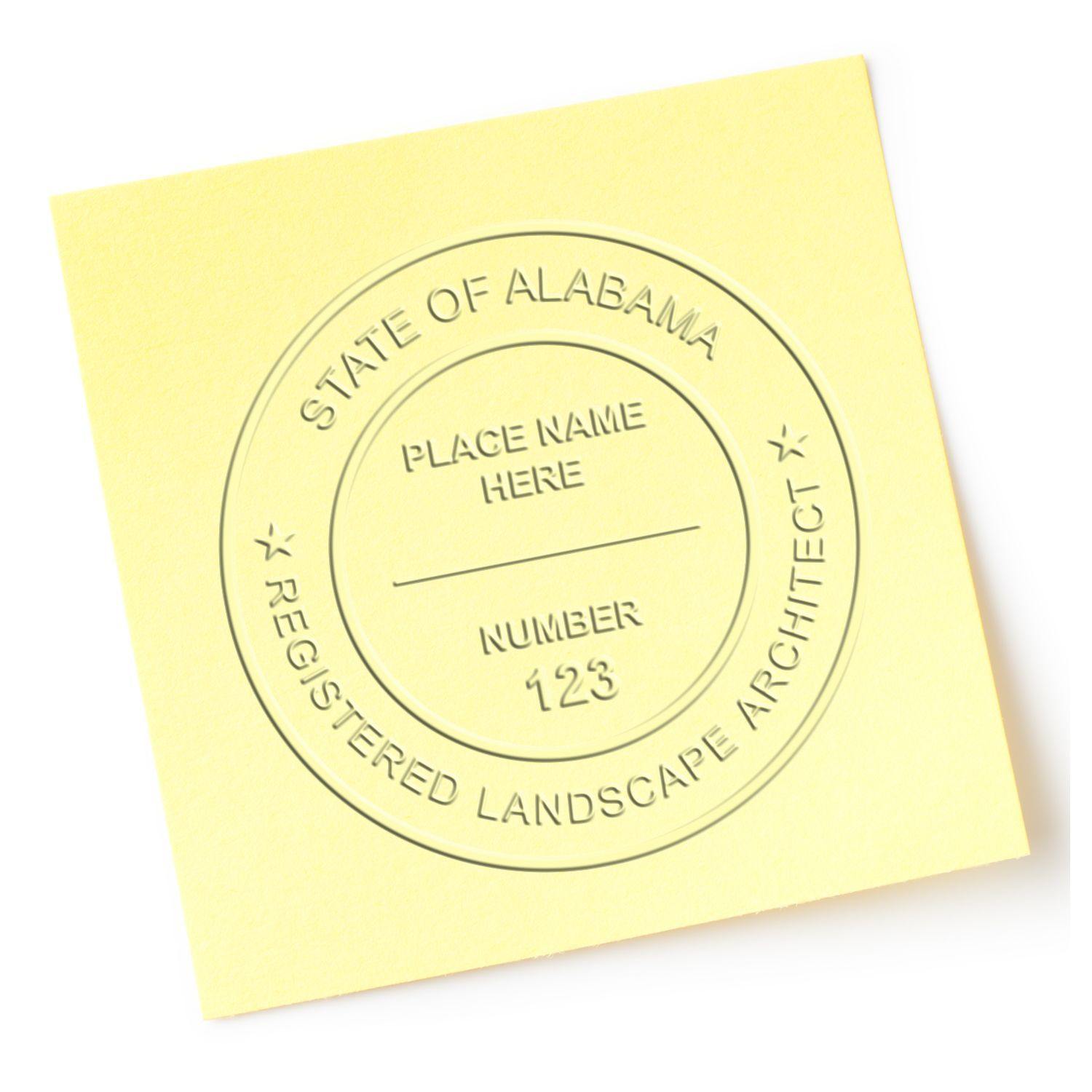 Yellow paper embossed with State of Alabama Registered Landscape Architect using the Landscape Architect Pink Soft Seal Embosser.