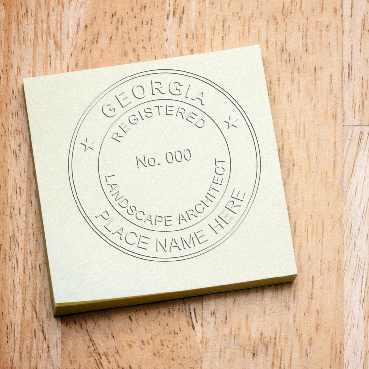 Landscape Architect Pink Soft Seal Embosser imprint on a yellow sticky note, displaying Georgia Registered Landscape Architect Place Name Here.