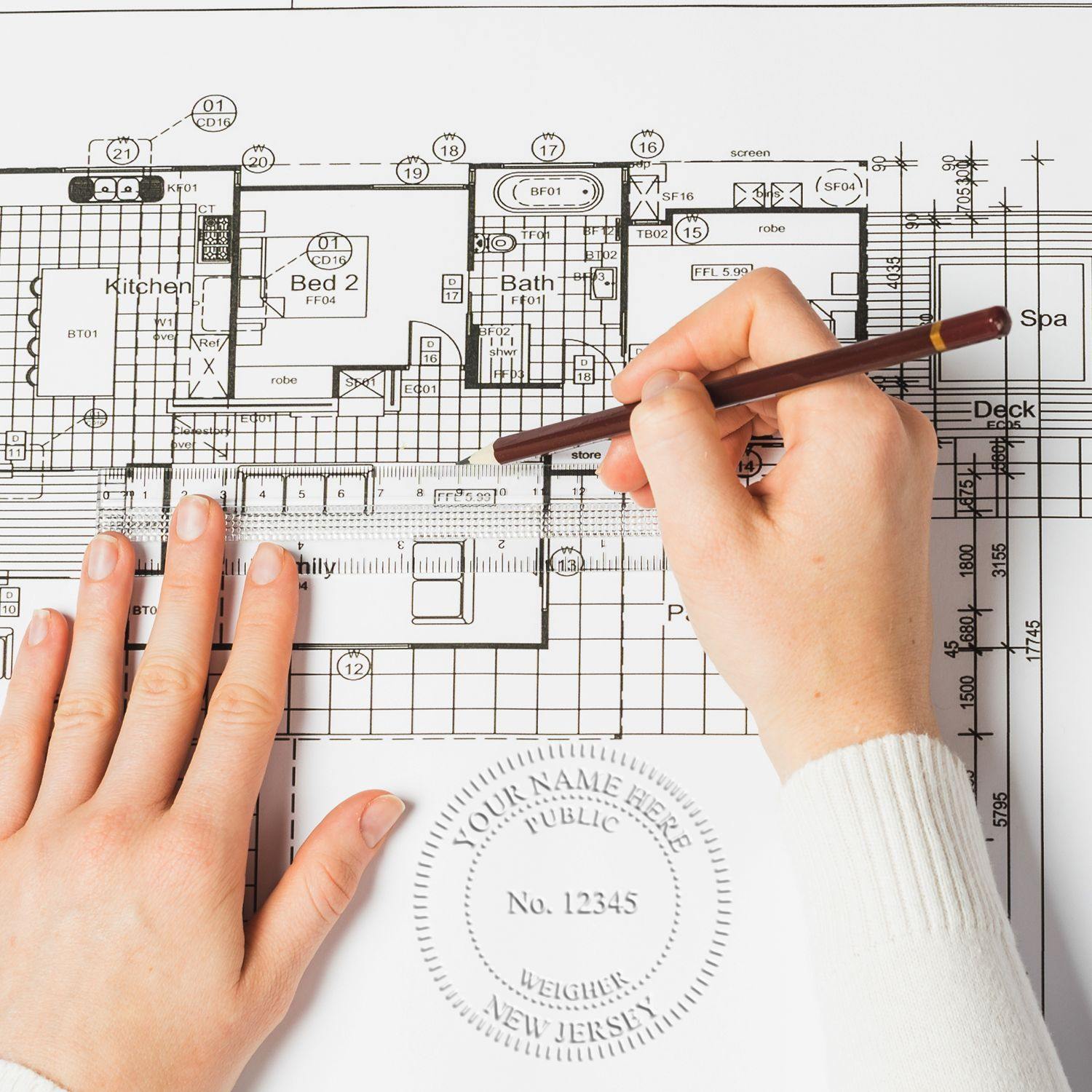 Hands using the Public Weighmaster Black Gift Seal Embosser on architectural plans, creating an embossed seal on the paper.