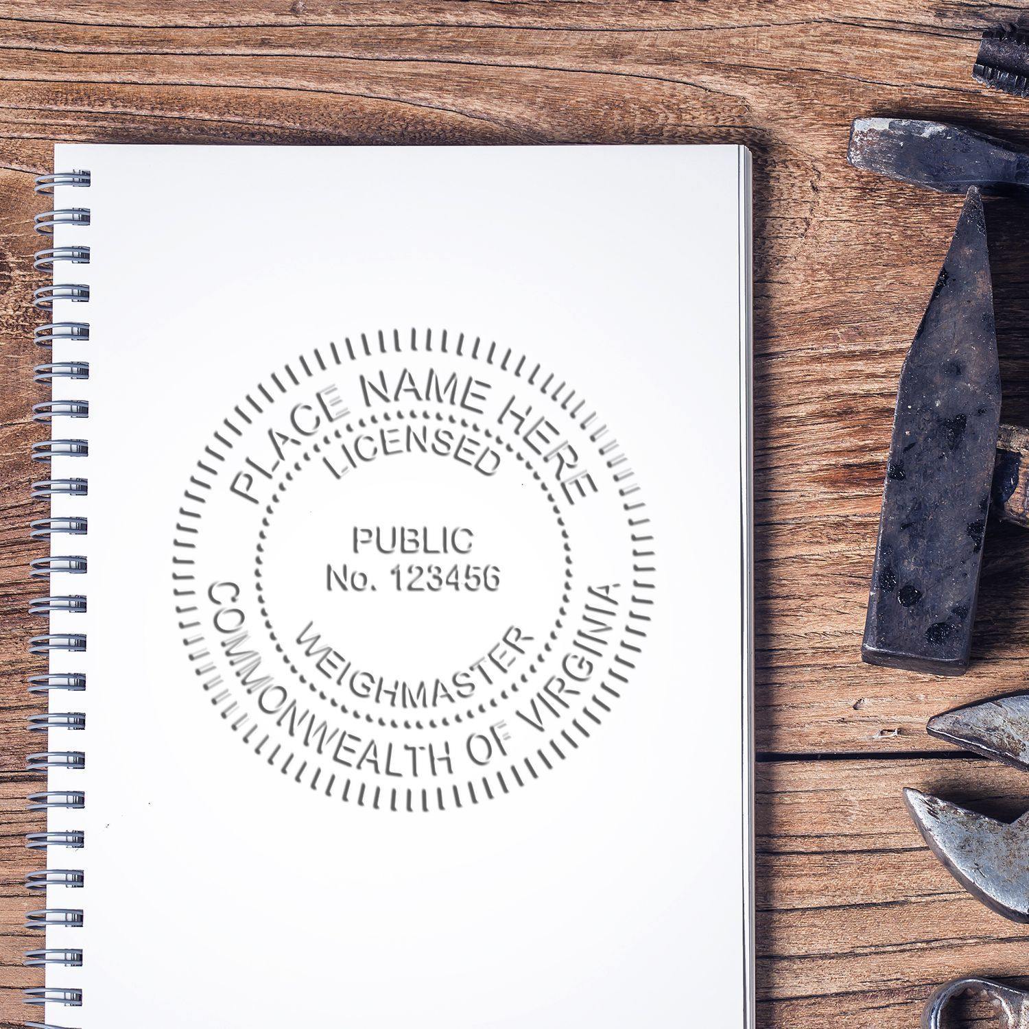 Public Weighmaster Desk Seal Embosser imprint on a spiral notebook, placed on a wooden desk with tools nearby.