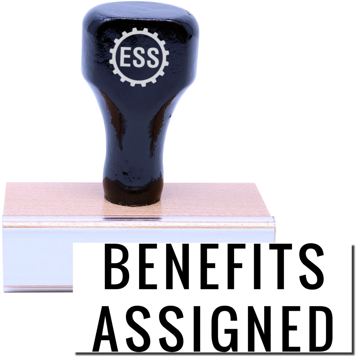 A stock office rubber stamp with a stamped image showing how the text "BENEFITS ASSIGNED" in a narrow font is displayed after stamping.