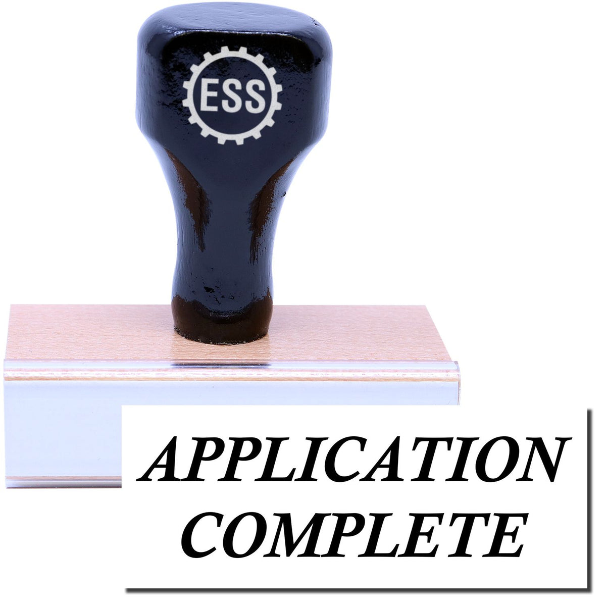 A stock office rubber stamp with a stamped image showing how the text &quot;APPLICATION COMPLETE&quot; is displayed after stamping.
