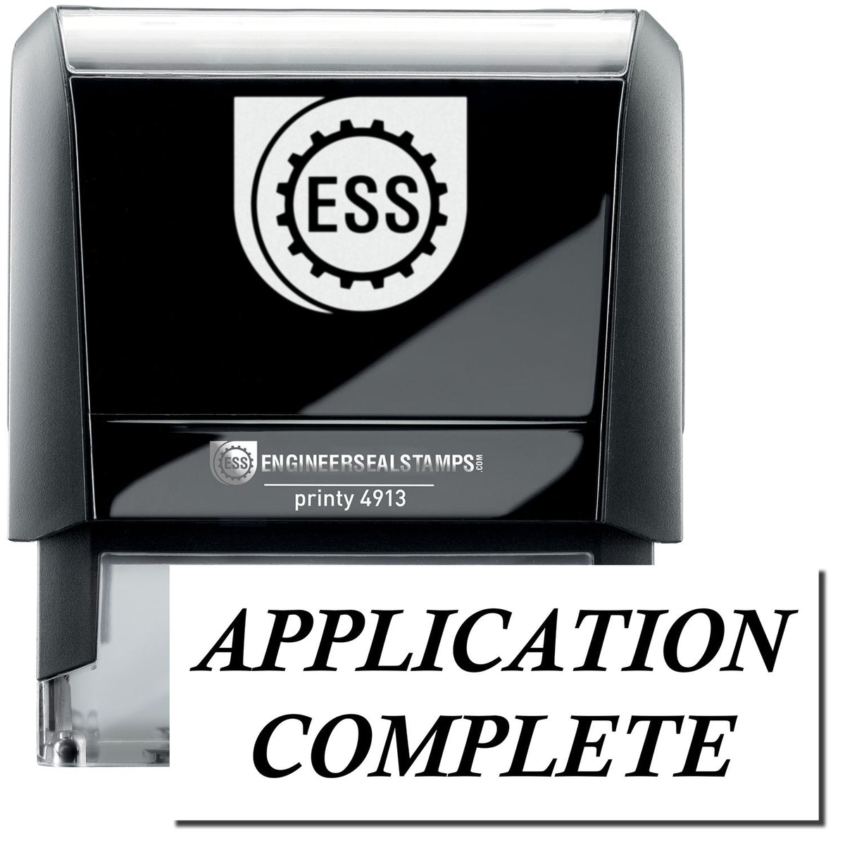 A self-inking stamp with a stamped image showing how the text &quot;APPLICATION COMPLETE&quot; in a large italic bold font is displayed by it.