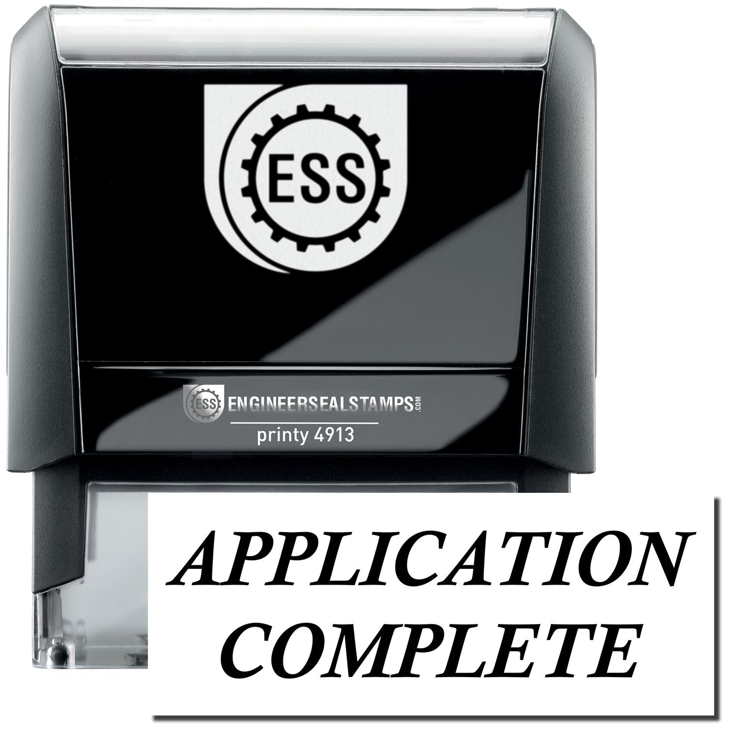 A self-inking stamp with a stamped image showing how the text "APPLICATION COMPLETE" in a large italic bold font is displayed by it.
