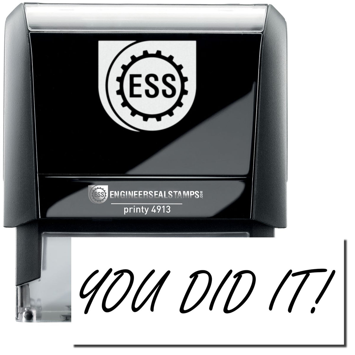 A self-inking stamp with a stamped image showing how the text &quot;YOU DID IT!&quot; in a large cursive font is displayed by it.