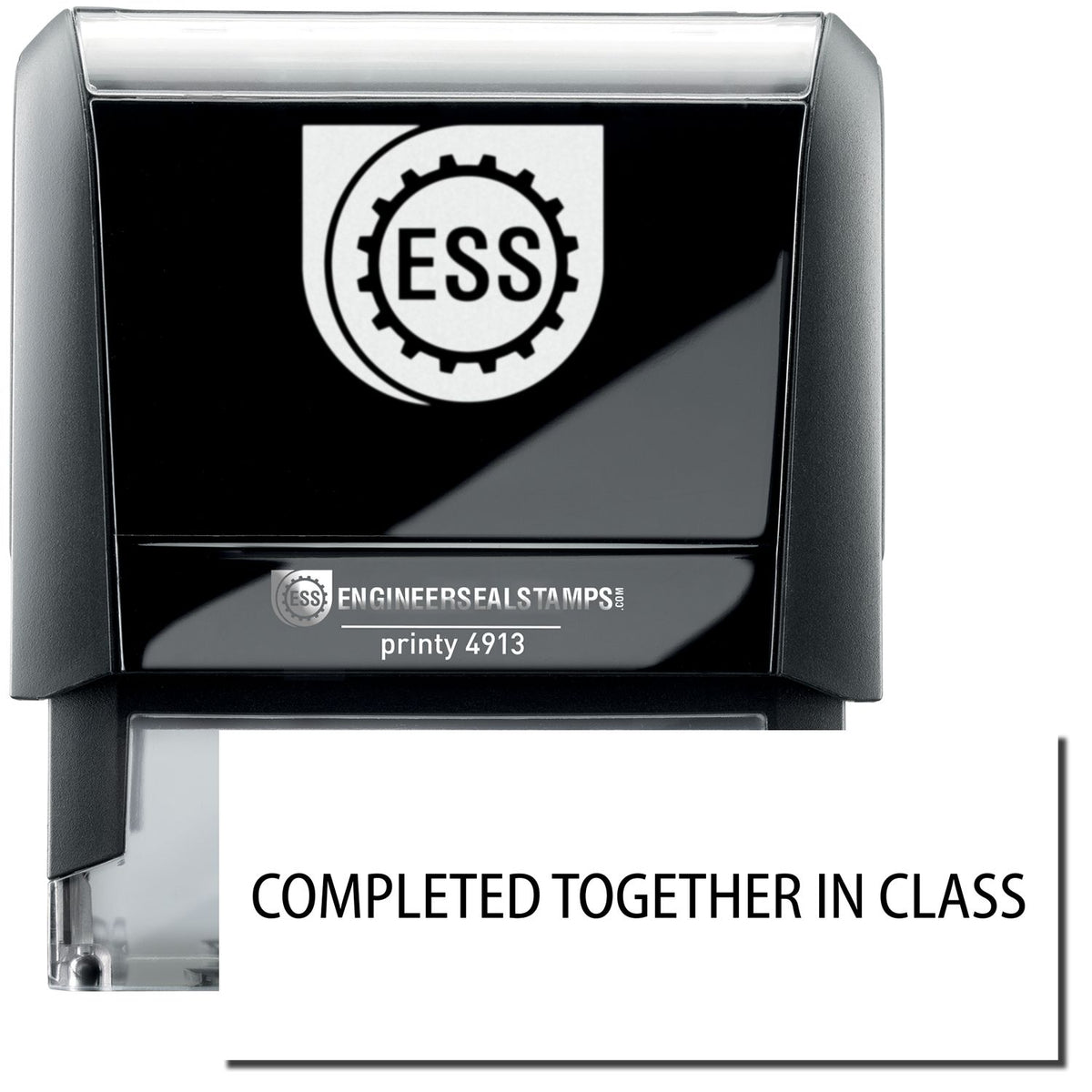 A self-inking stamp with a stamped image showing how the text &quot;COMPLETED TOGETHER IN CLASS&quot; in a large font is displayed by it after stamping.