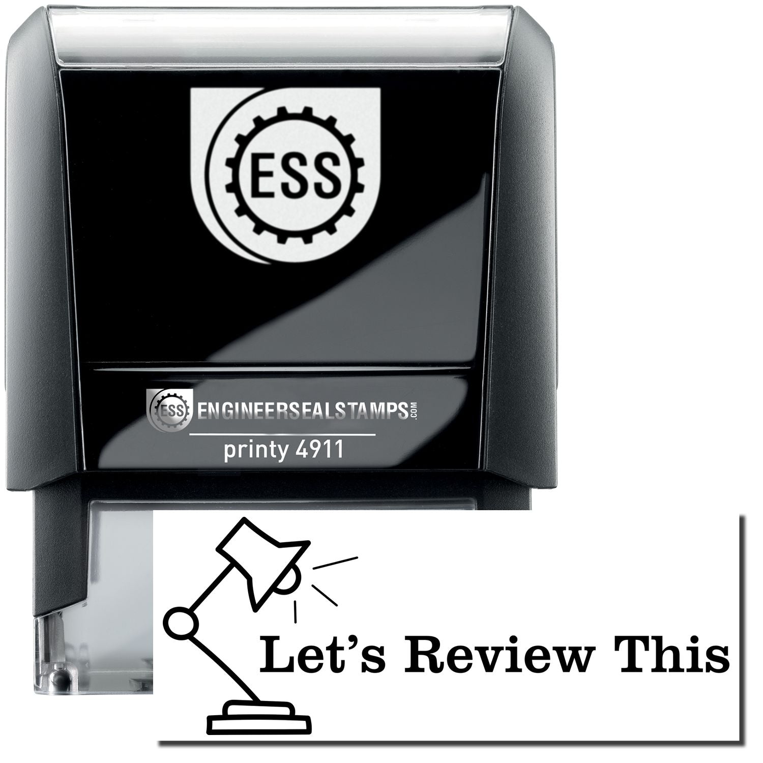 A self-inking stamp with a stamped image showing how the text "Let's Review This" (in bold font with an image of a lamp on the left side) is displayed after stamping.