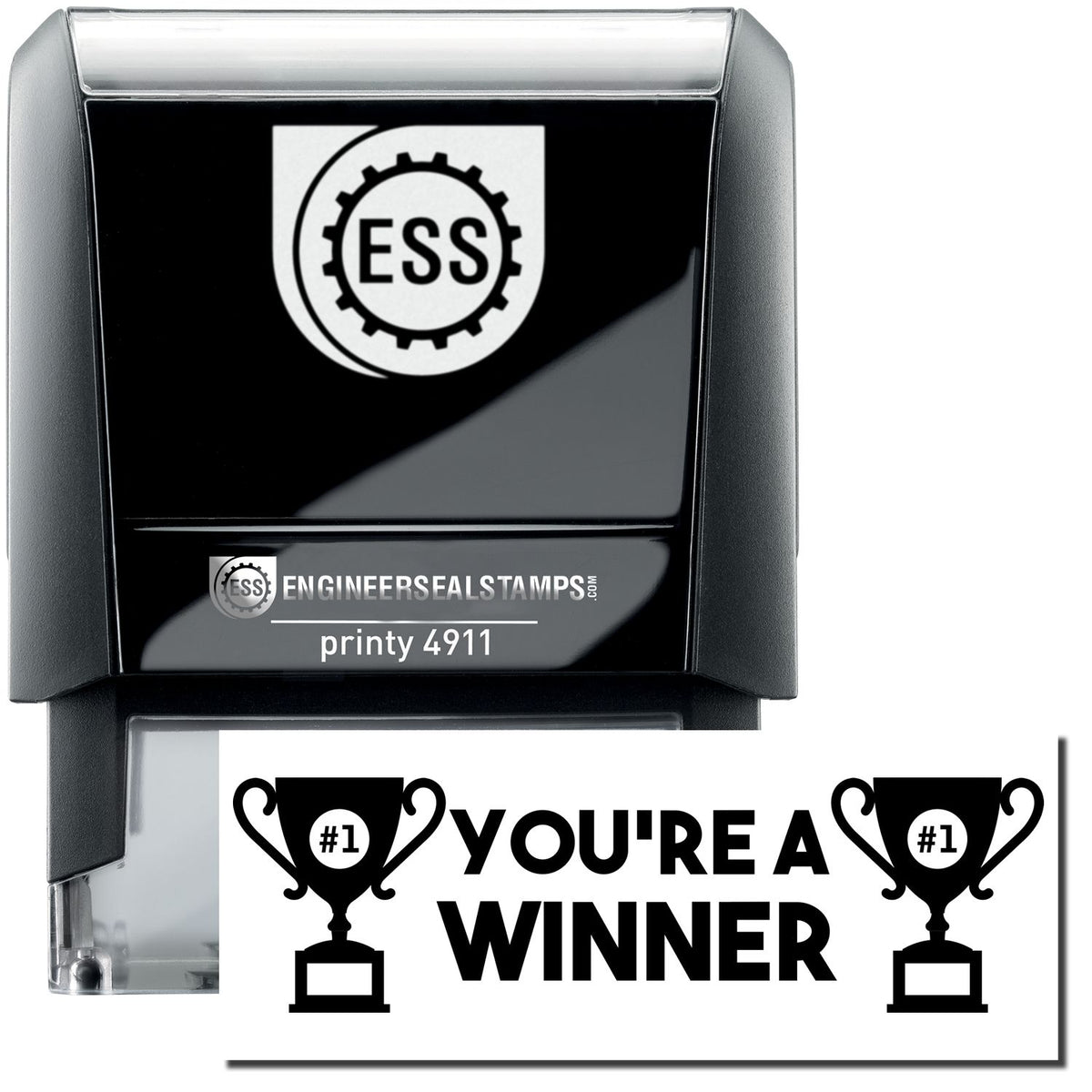 A self-inking stamp with a stamped image showing how the text &quot;YOU&#39;RE A WINNER&quot; (in bold font with images of a trophy with #1 inside on each side) is displayed after stamping.