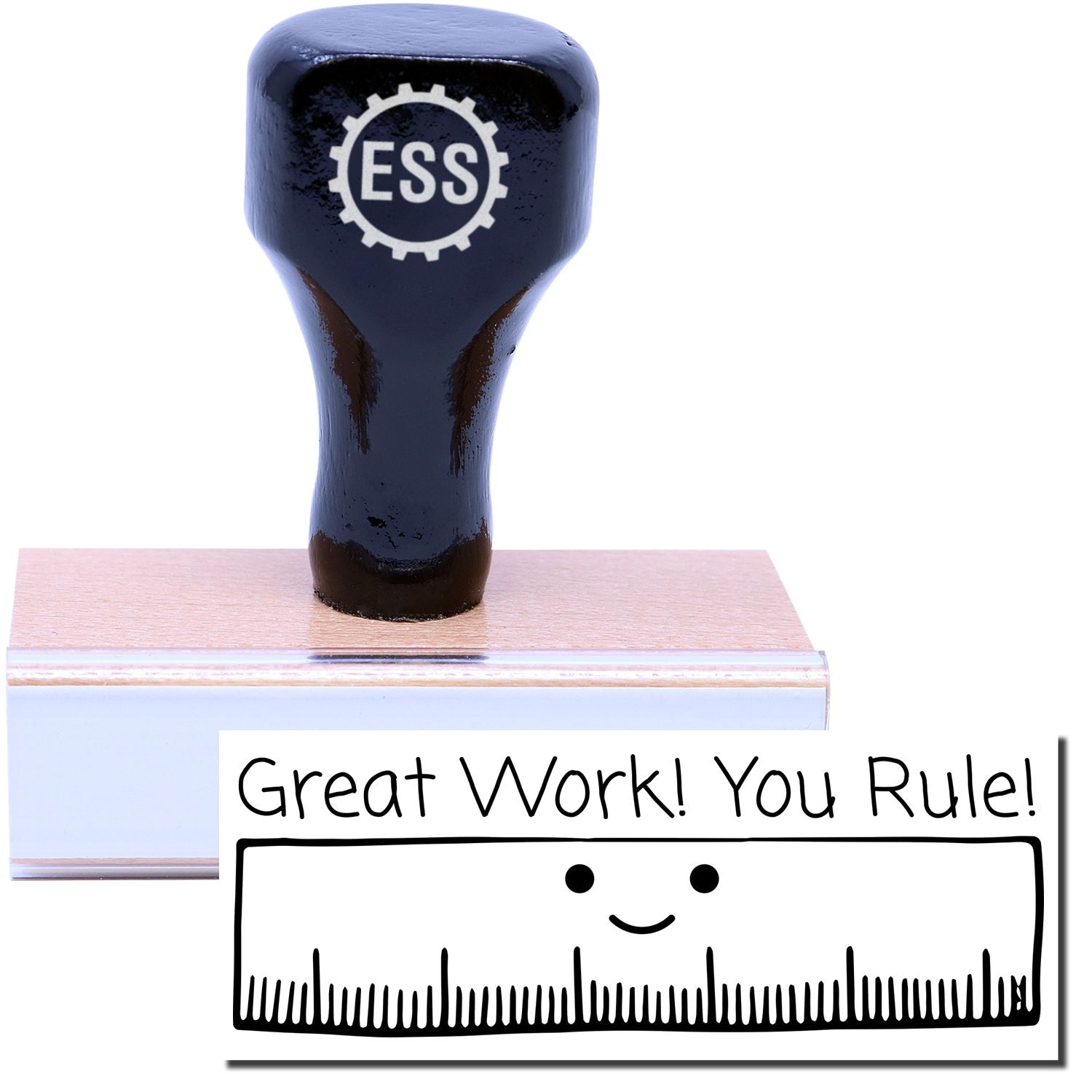 A stock office rubber stamp with a stamped image showing how the text Great Work! You Rule! in a large font with a large image of a ruler with a smiling face underneath is displayed after stamping.