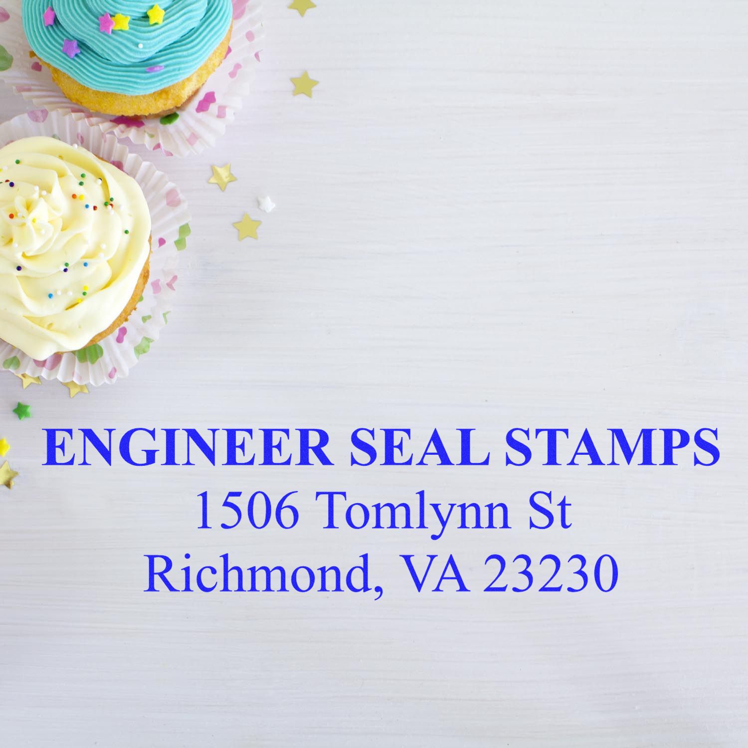 3 Line Self Inking Address Stamp by Engineer Seal Stamps on a white surface with cupcakes and star-shaped confetti in the background.