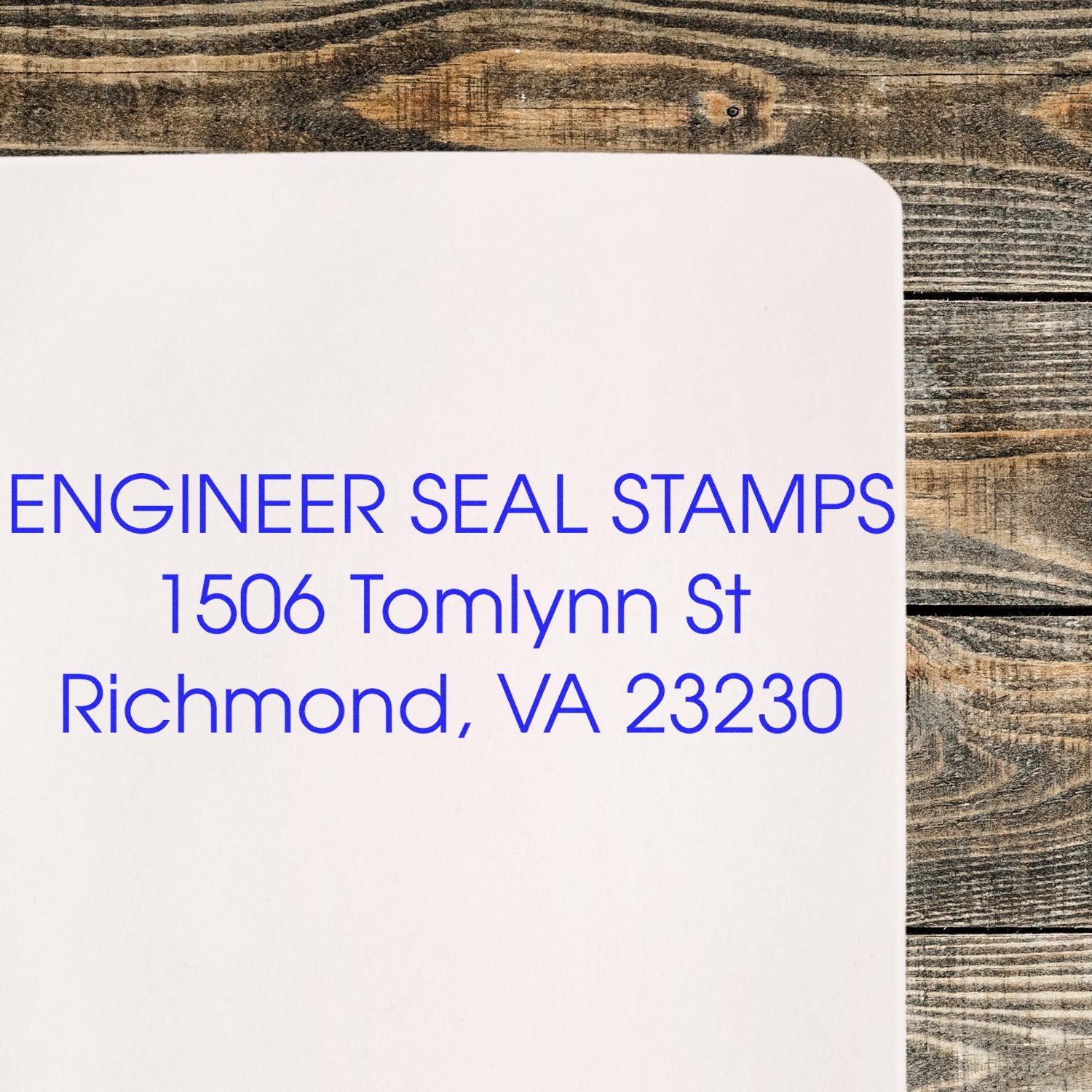 3 Line Self Inking Address Stamp used on white paper, displaying ENGINEER SEAL STAMPS, 1506 Tomlynn St, Richmond, VA 23230 in blue ink.