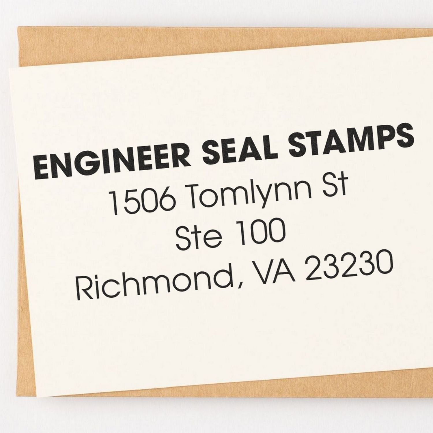 4 Line Address Stamp Regular Rubber Stamp used to imprint ENGINEER SEAL STAMPS, 1506 Tomlynn St, Ste 100, Richmond, VA 23230 on a white card.