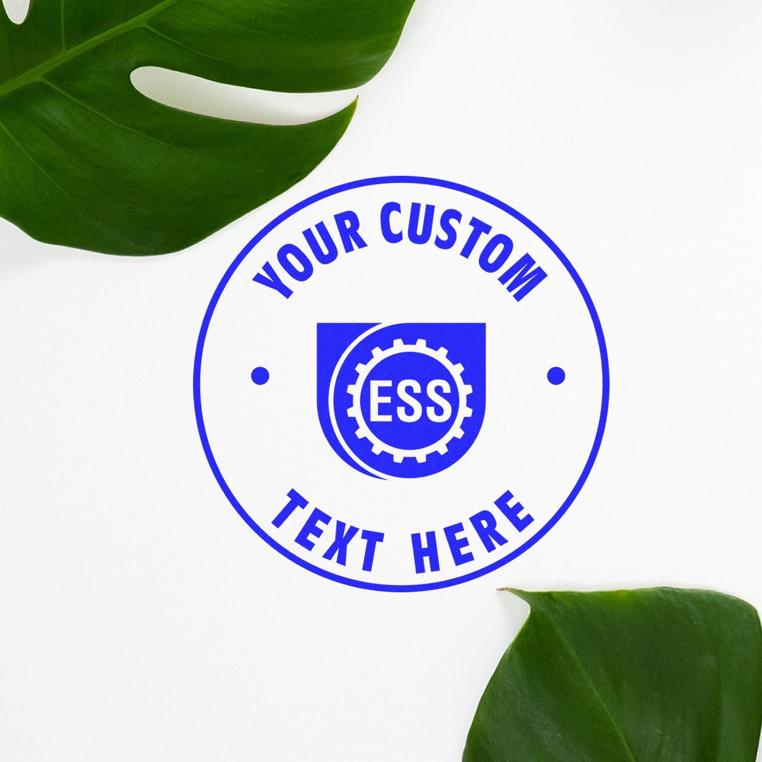 Custom Rubber Stamp Size 1-1/2 Inch Diameter with Your Custom Text Here in blue ink, surrounded by green leaves on a white background.