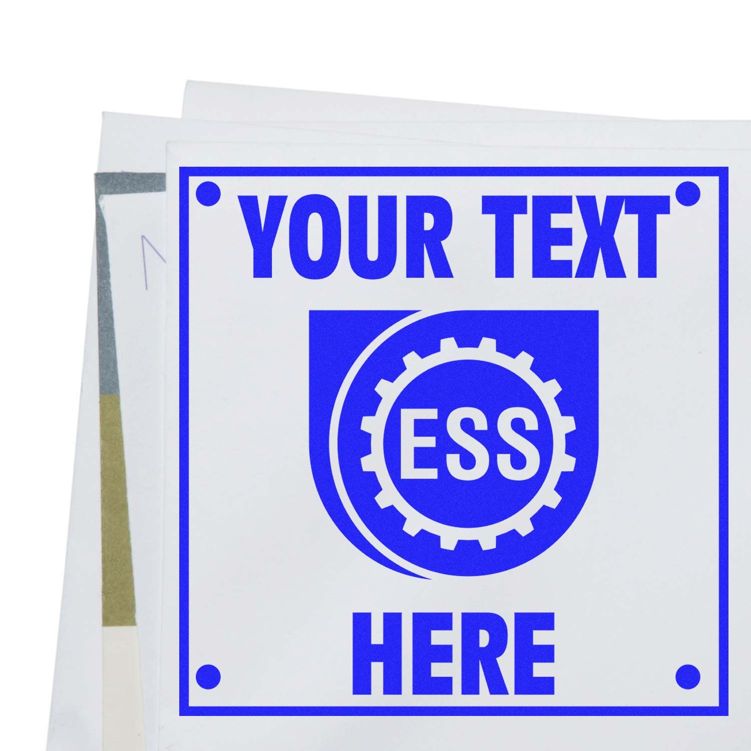 Custom Rubber Stamp Size 5 x 5 in blue ink, displaying YOUR TEXT HERE with the ESS logo, placed on a stack of papers.