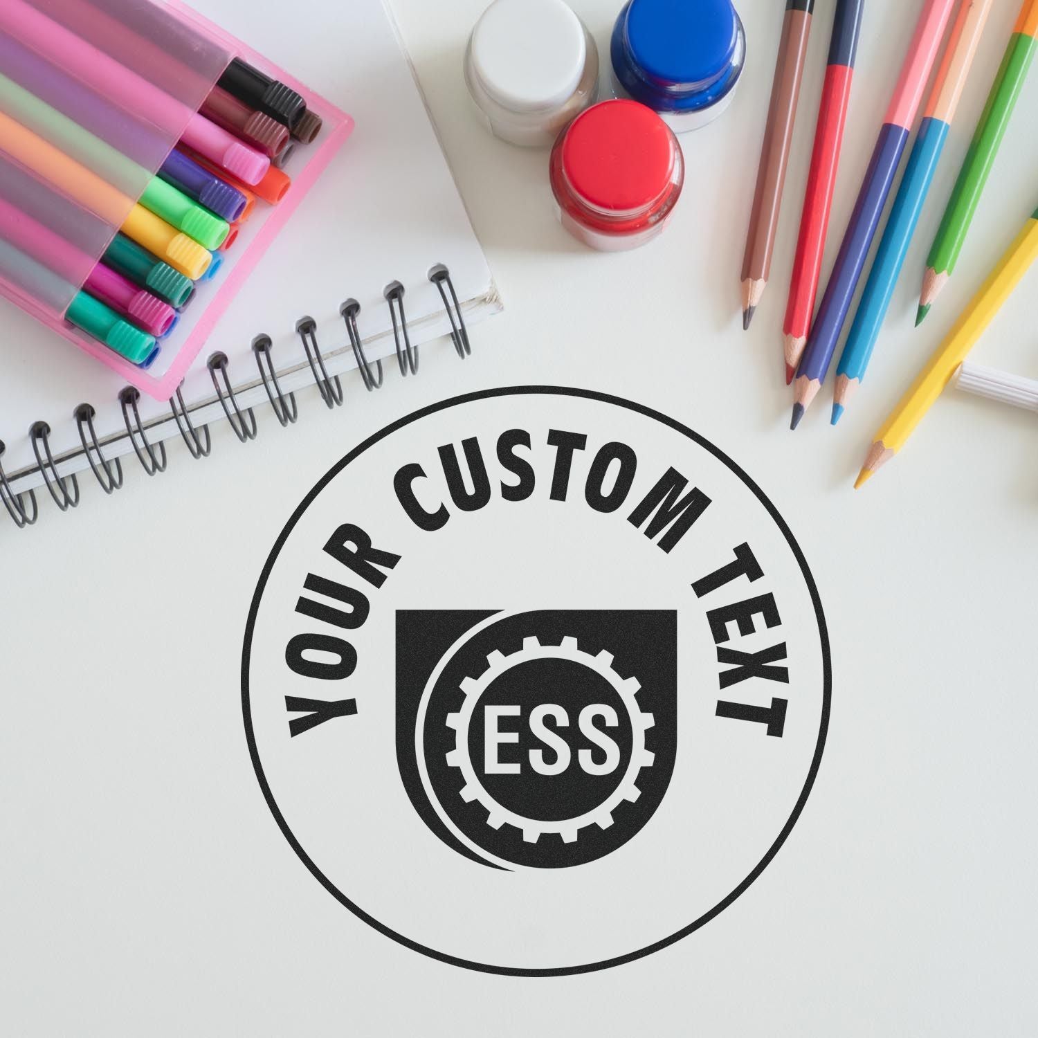 Custom Rubber Stamp Size 7 Inch Diameter in use, surrounded by colorful pens, markers, and a notebook on a white surface.