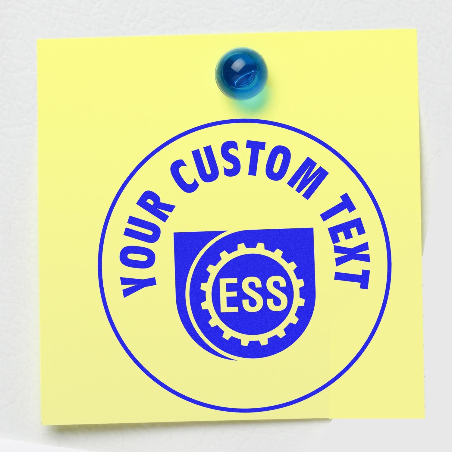 Yellow sticky note with a blue pin, featuring a blue ESS logo and YOUR CUSTOM TEXT on a Custom Rubber Stamp Size 7 Inch Diameter.