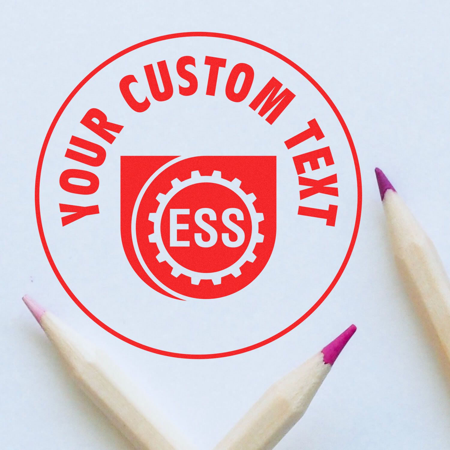 Custom Rubber Stamp Size 3 Inch Diameter with Your Custom Text in red ink, surrounded by three colored pencils on a white background.