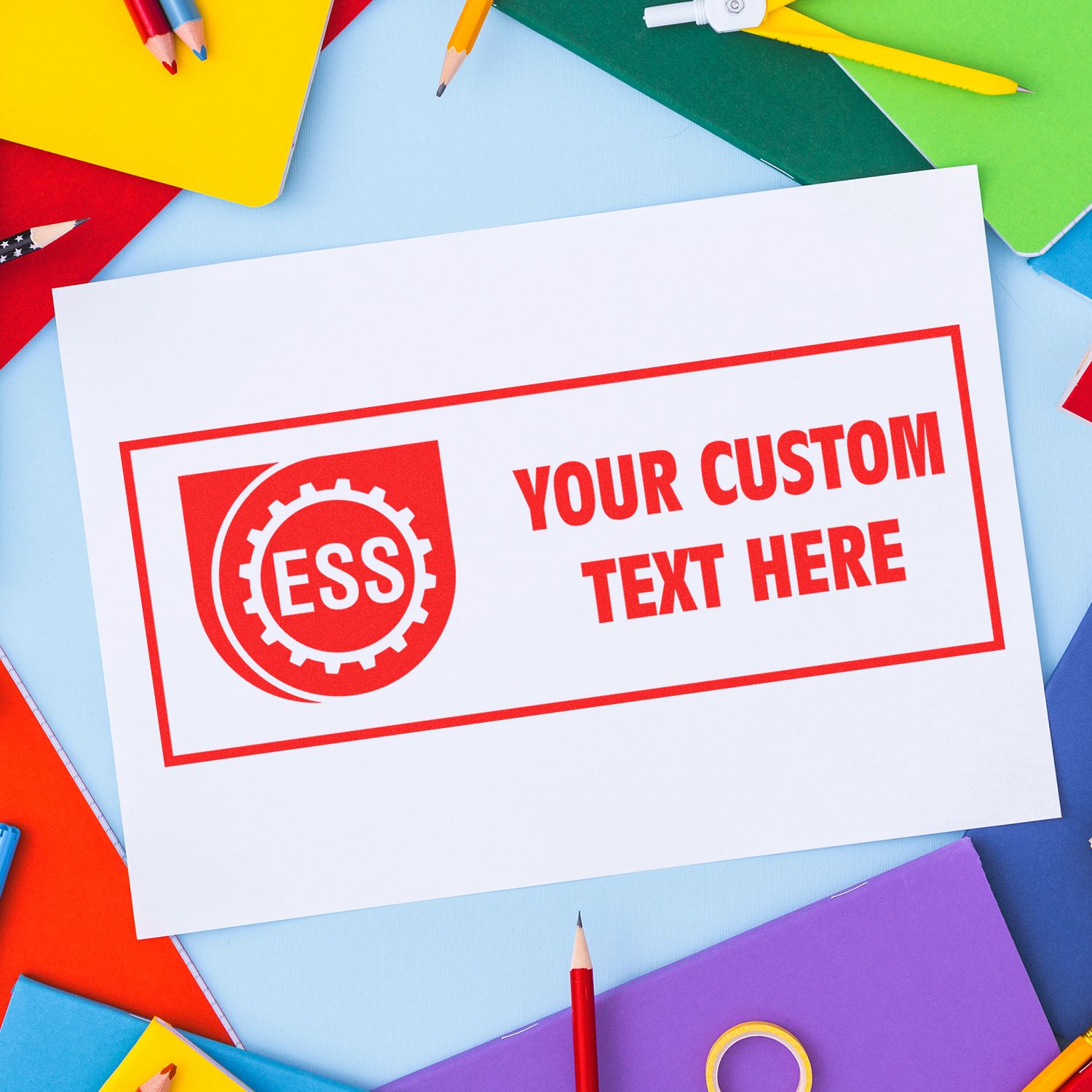 Custom Rubber Stamp Size 4 x 5 imprint on white paper with ESS logo and Your Custom Text Here in red, surrounded by colorful stationery.