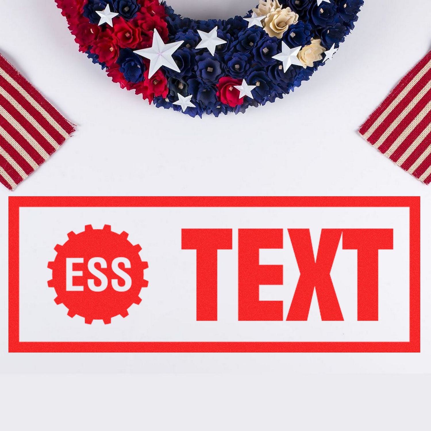 Custom Rubber Stamp Size 1-1/2 x 2 in use, displaying ESS TEXT in bold red letters, with a patriotic wreath and striped fabric in the background.