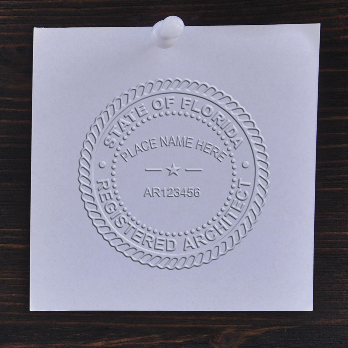 An alternative view of the State of Florida Long Reach Architectural Embossing Seal stamped on a sheet of paper showing the image in use