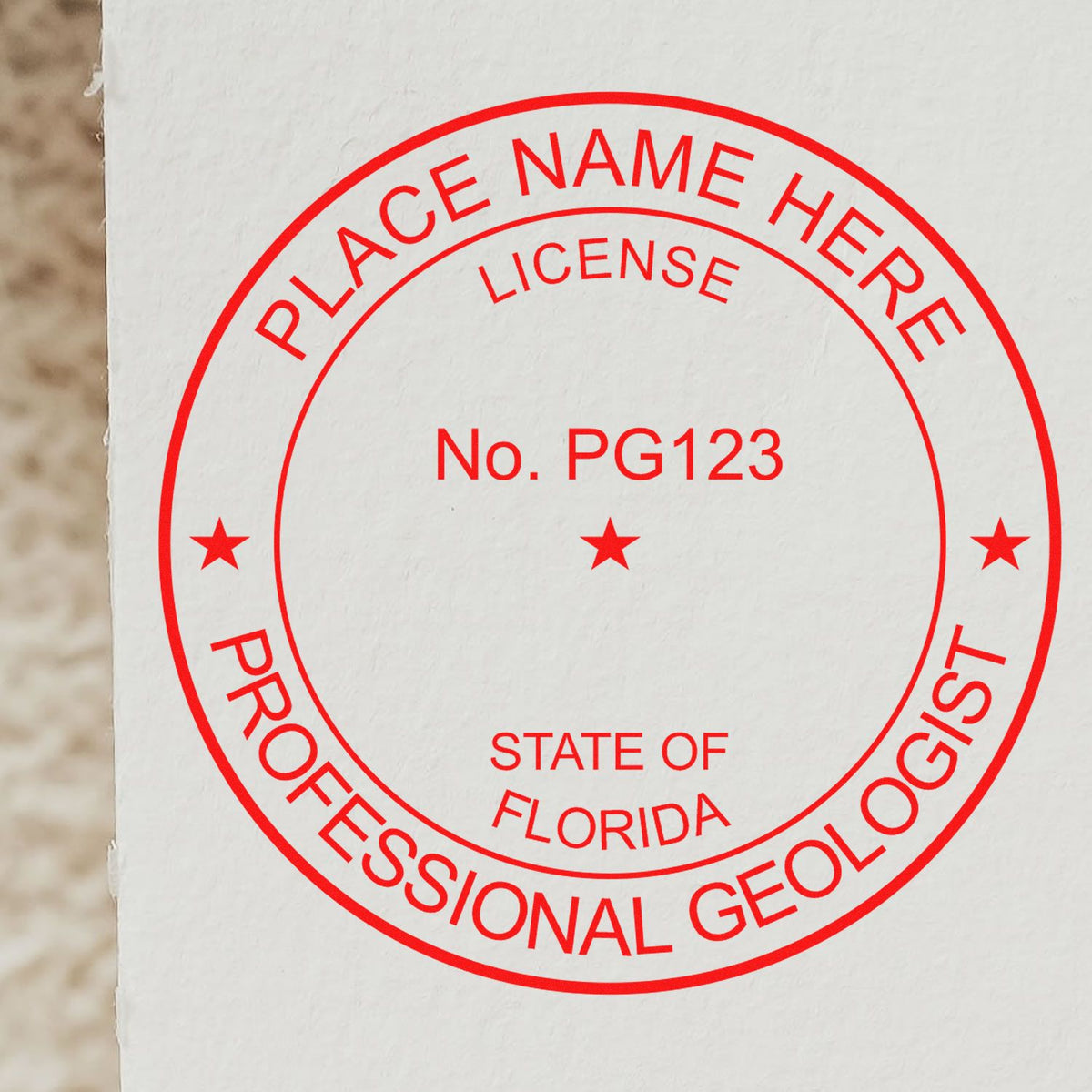 An in use photo of the Florida Professional Geologist Seal Stamp showing a sample imprint on a cardstock