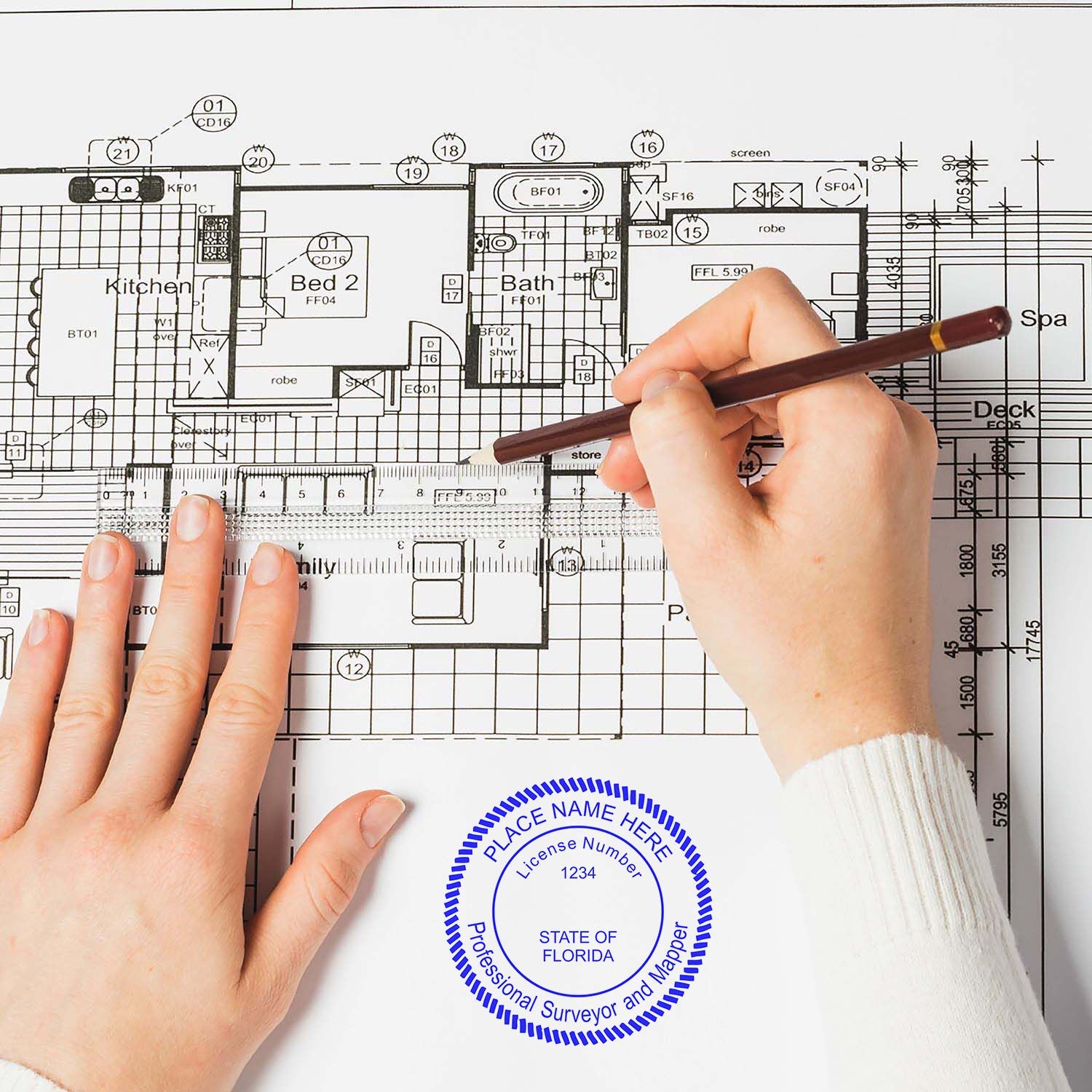 Hands holding a pen over a blueprint with a Digital Florida Land Surveyor Stamp, Electronic Seal for Florida Land Surveyor visible on the paper.