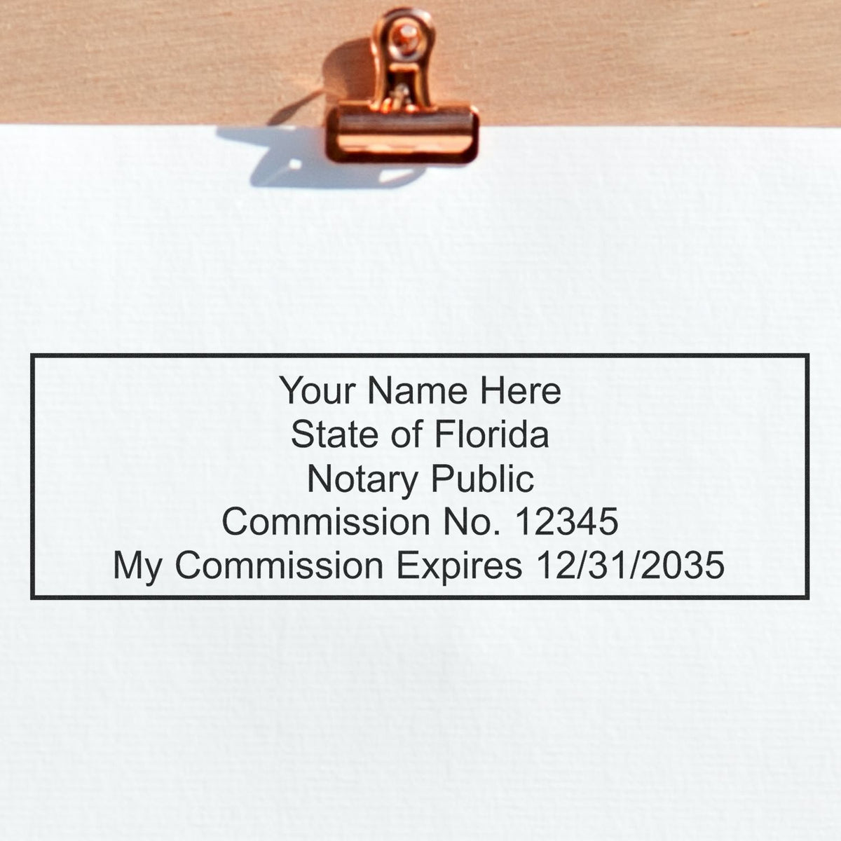 A lifestyle photo showing a stamped image of the Wooden Handle Florida Rectangular Notary Public Stamp on a piece of paper