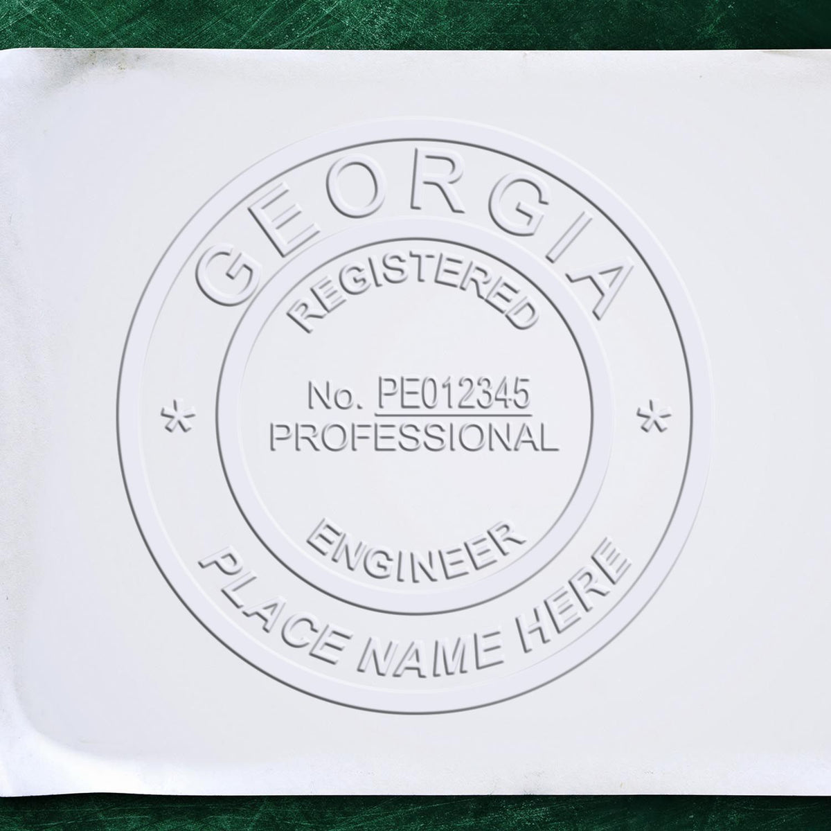 A lifestyle photo showing a stamped image of the Handheld Georgia Professional Engineer Embosser on a piece of paper