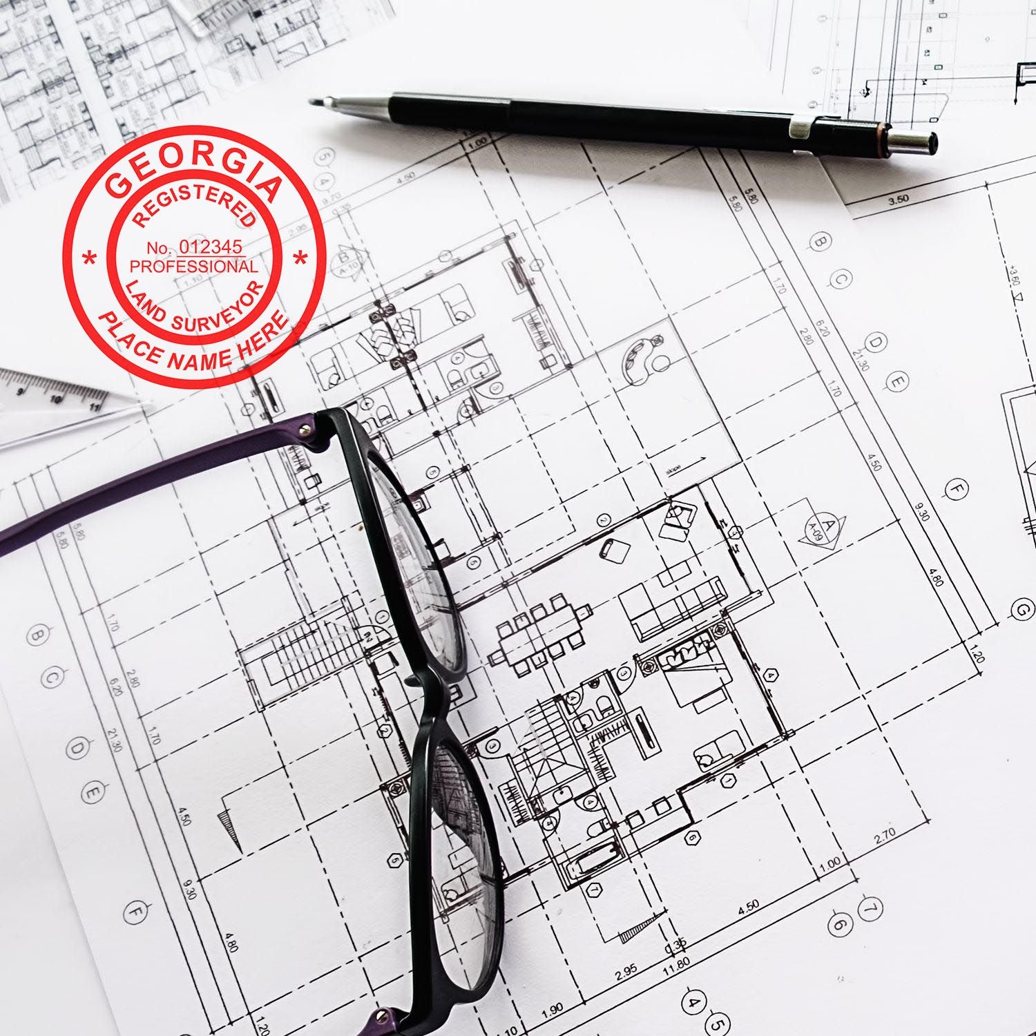 Digital Georgia Land Surveyor Stamp, Electronic Seal for Georgia Land Surveyor on architectural plans with glasses and pen nearby.