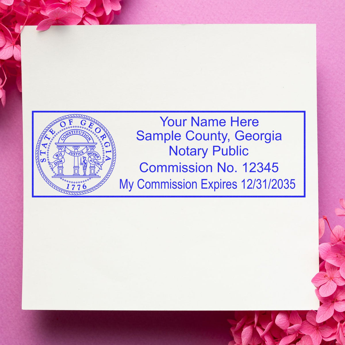 A lifestyle photo showing a stamped image of the Wooden Handle Georgia Rectangular Notary Public Stamp on a piece of paper