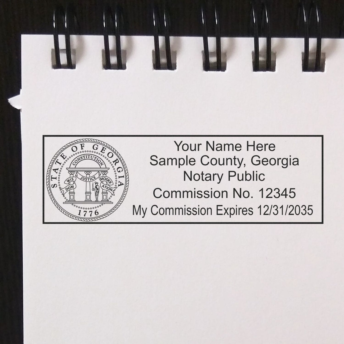 The main image for the Wooden Handle Georgia Rectangular Notary Public Stamp depicting a sample of the imprint and electronic files