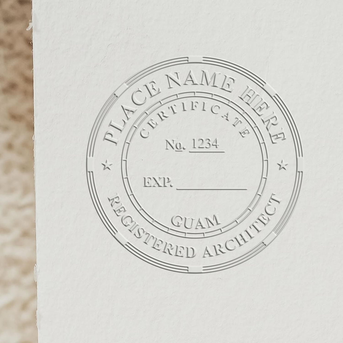 Extended Long Reach Guam Architect Seal Embosser in use photo showing a stamped imprint of the Extended Long Reach Guam Architect Seal Embosser