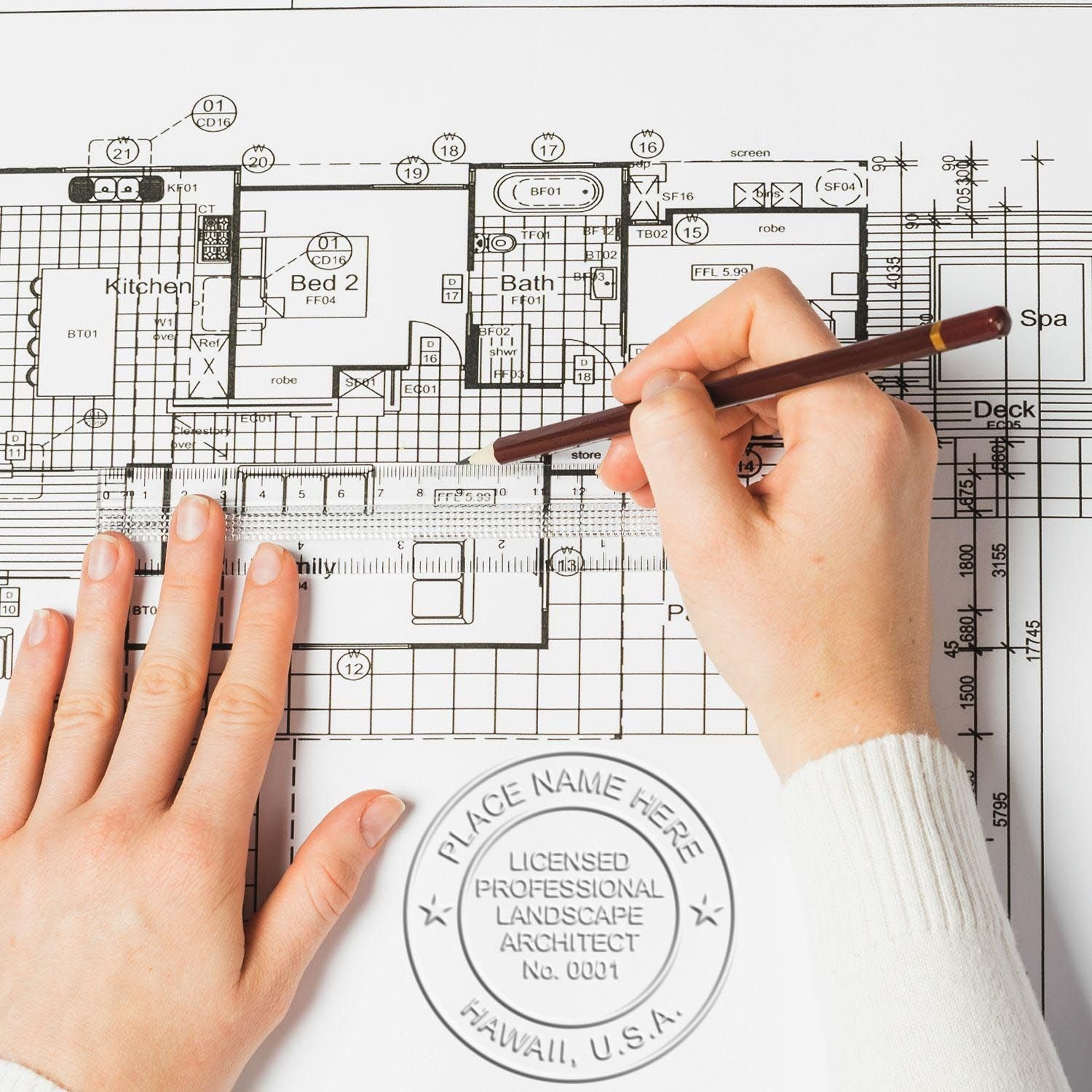 An in use photo of the Gift Hawaii Landscape Architect Seal showing a sample imprint on a cardstock