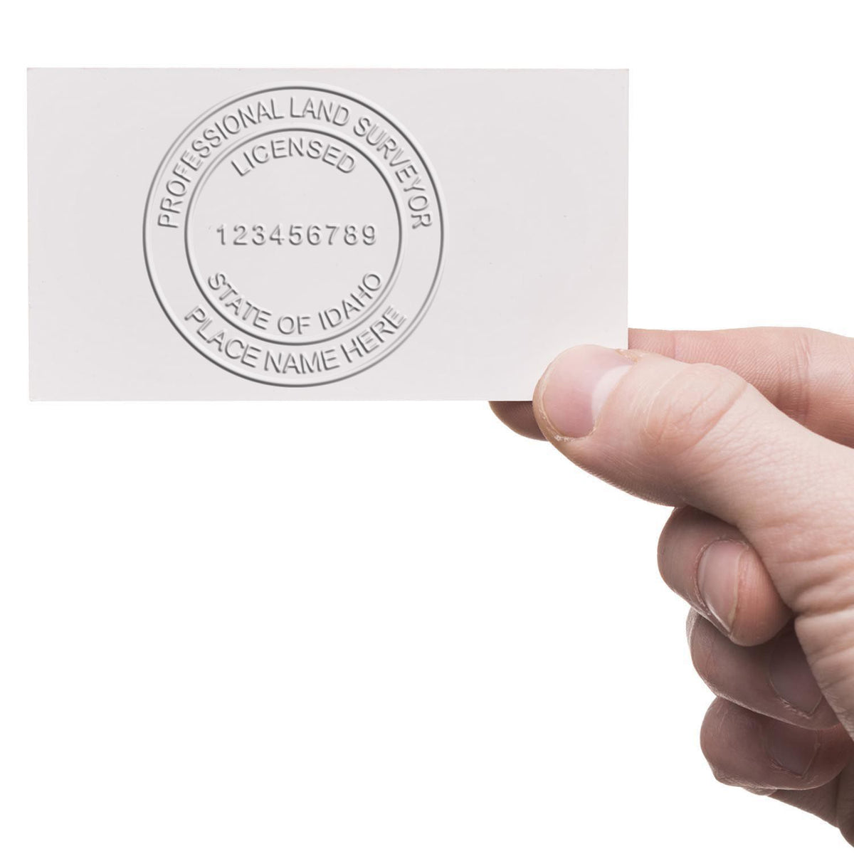 An alternative view of the Handheld Idaho Land Surveyor Seal stamped on a sheet of paper showing the image in use