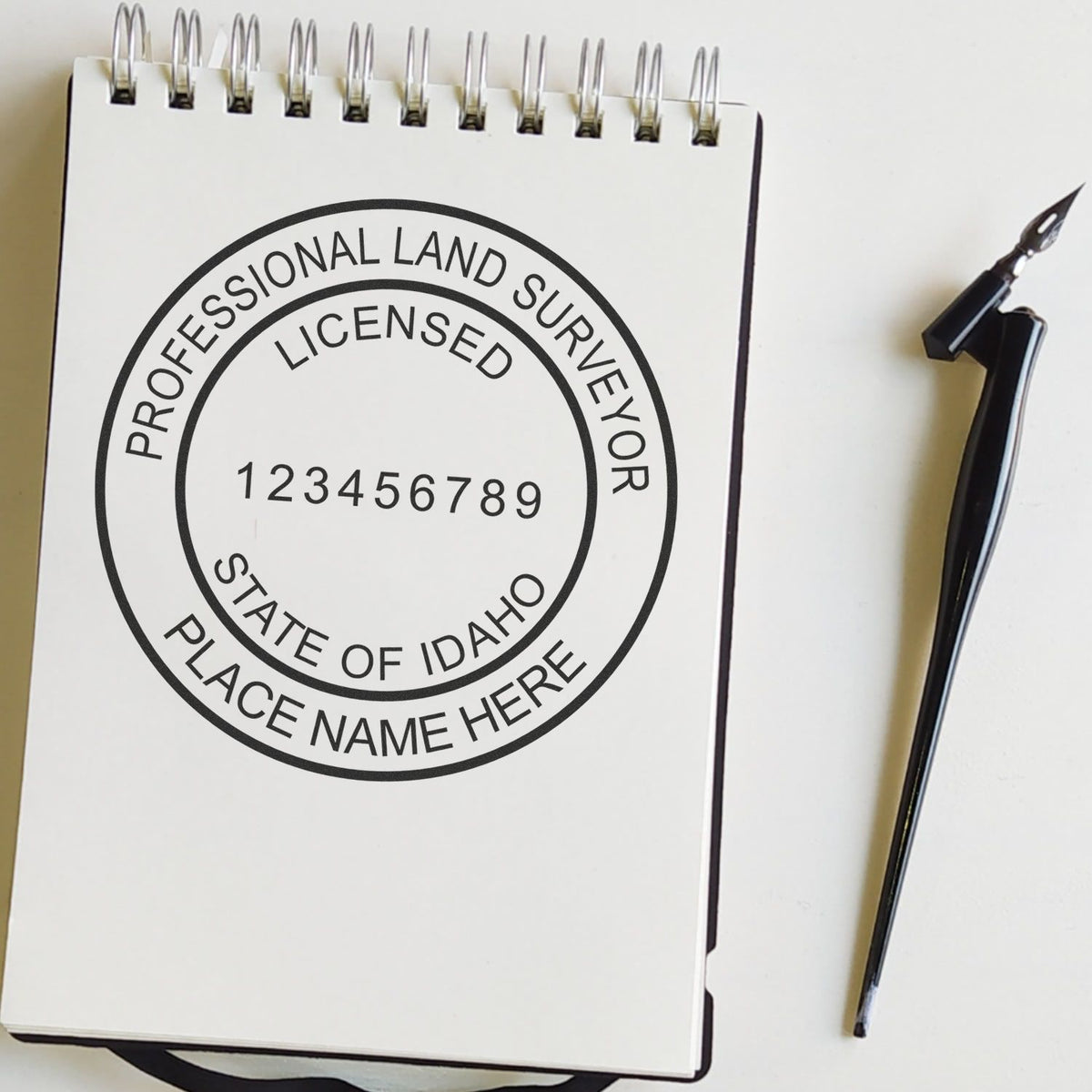 An alternative view of the Slim Pre-Inked Idaho Land Surveyor Seal Stamp stamped on a sheet of paper showing the image in use