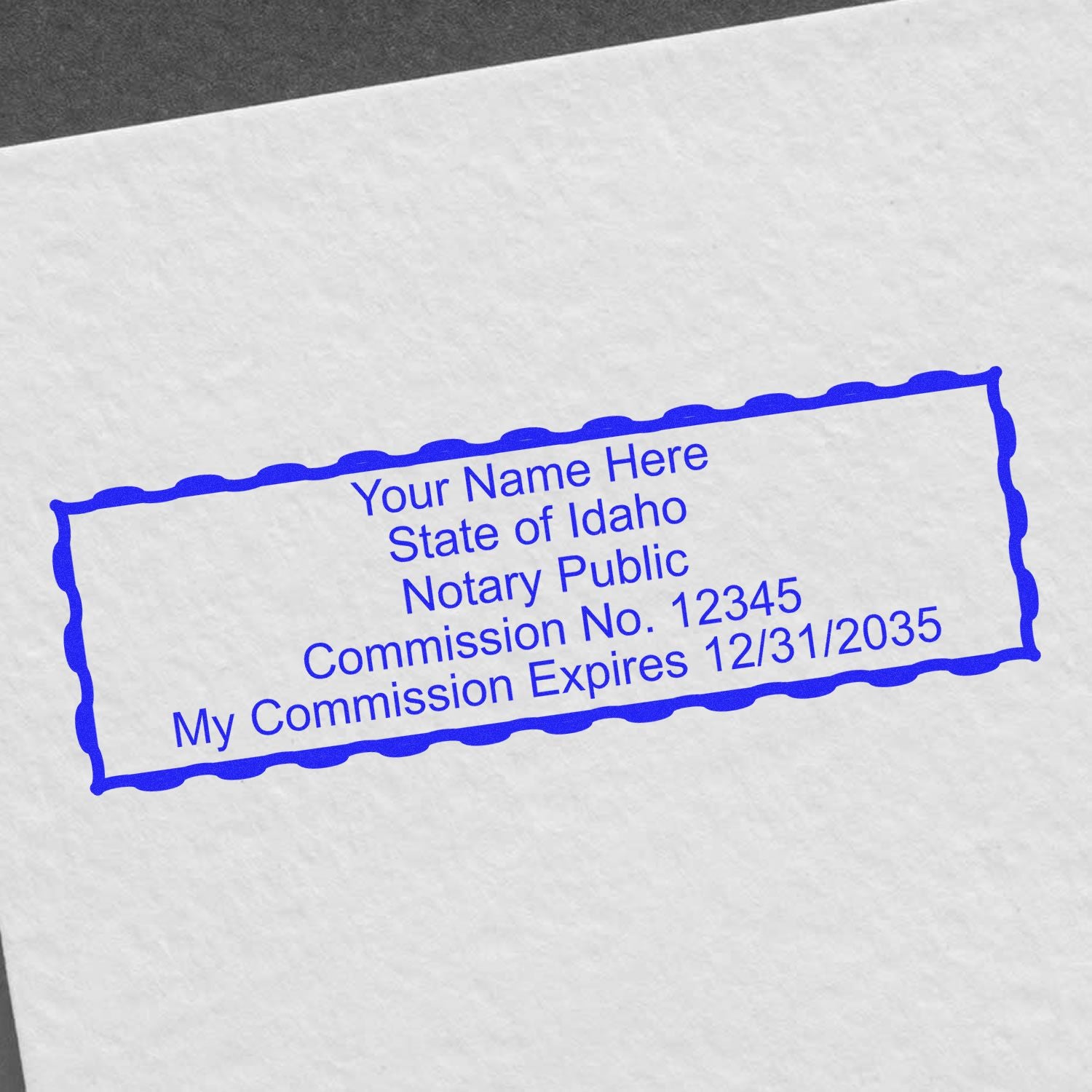 A lifestyle photo showing a stamped image of the Idaho Rectangular Digital Notary Seal on a piece of paper