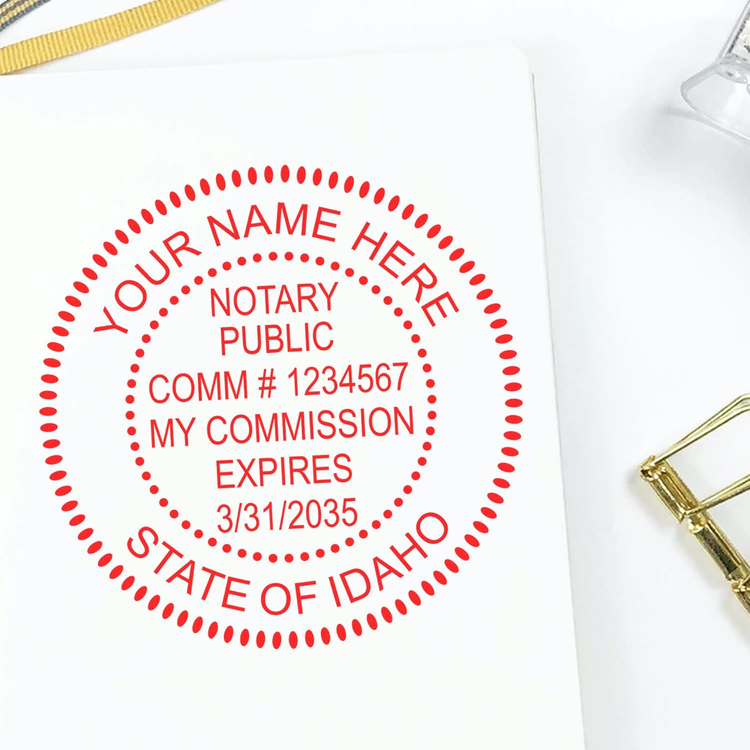 An alternative view of the Official Self-Inking Idaho Notary Stamp stamped on a sheet of paper showing the image in use