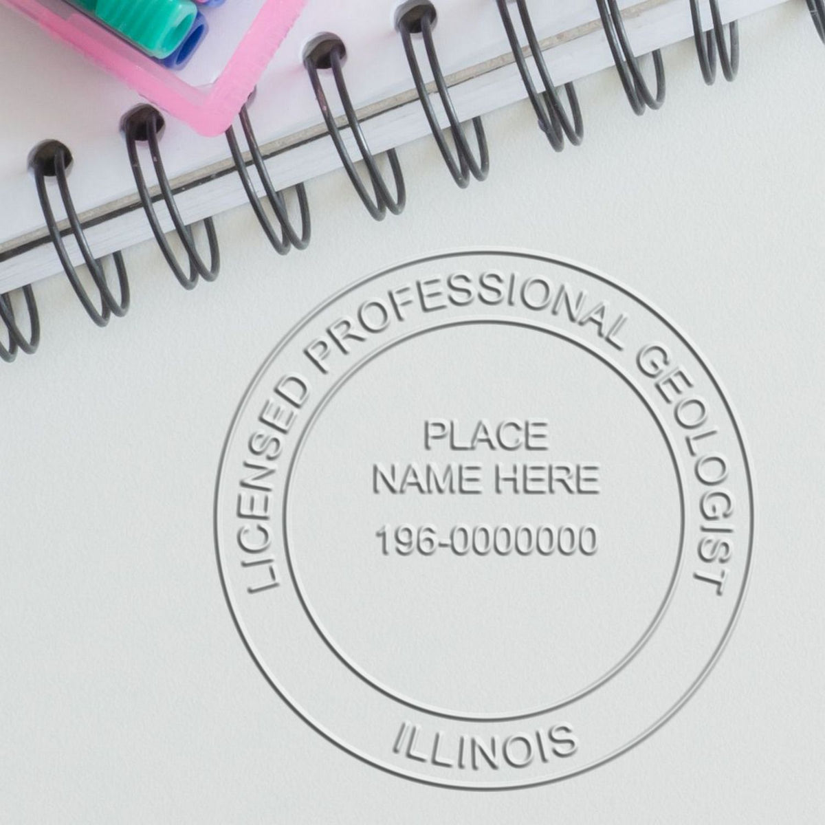 An alternative view of the Handheld Illinois Professional Geologist Embosser stamped on a sheet of paper showing the image in use