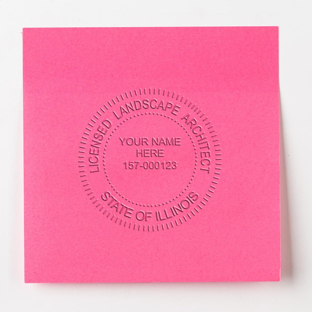 An in use photo of the Gift Illinois Landscape Architect Seal showing a sample imprint on a cardstock