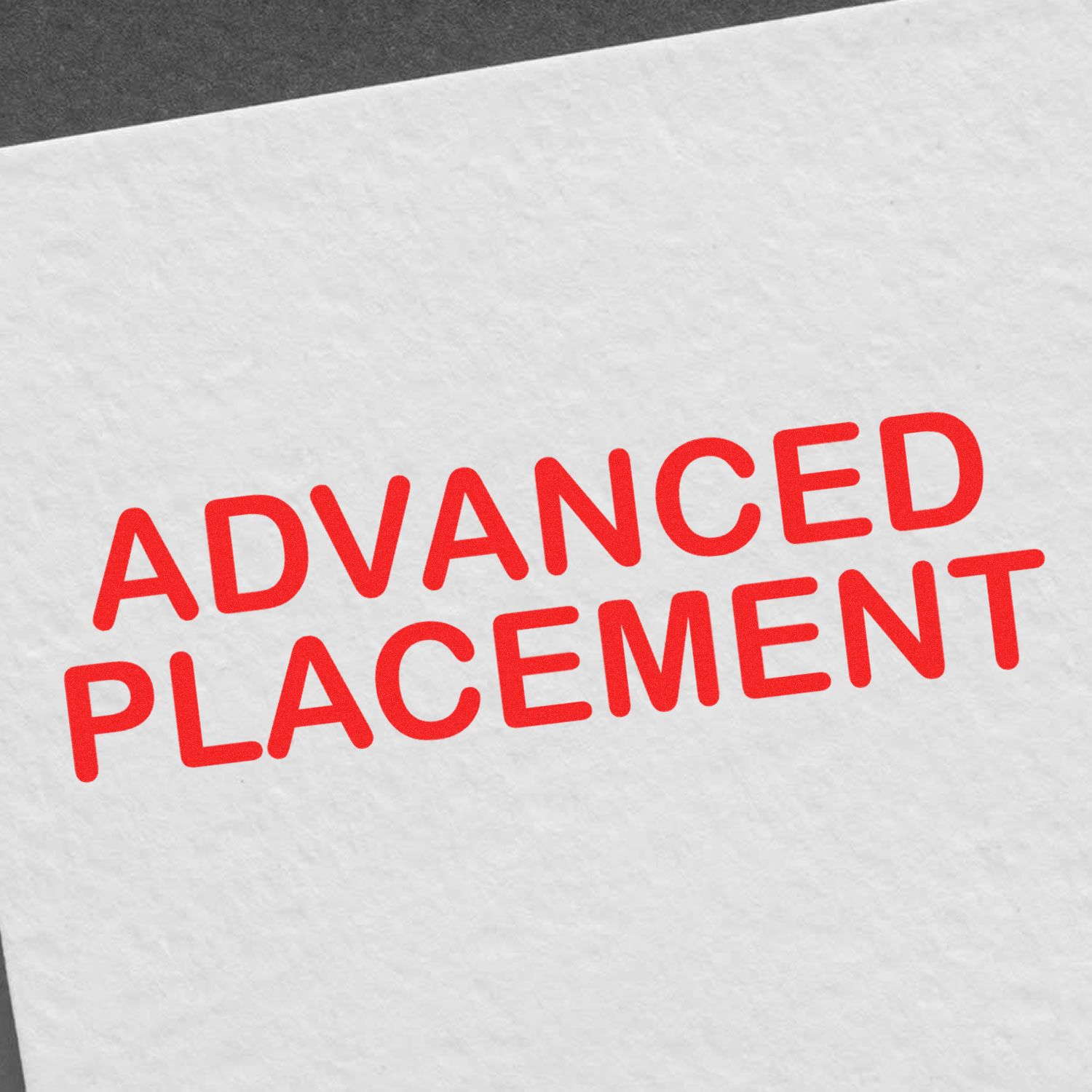 A white paper stamped with the red text 'ADVANCED PLACEMENT' using the Advanced Placement Rubber Stamp."