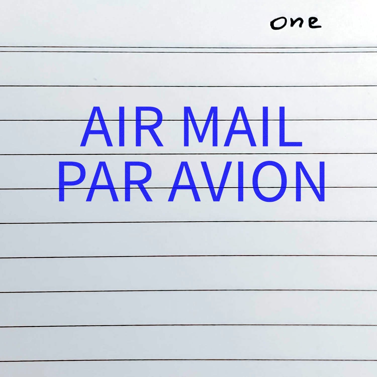 Self Inking Air Mail Par Avion Stamp in blue ink on lined paper with the word one handwritten in the top right corner.