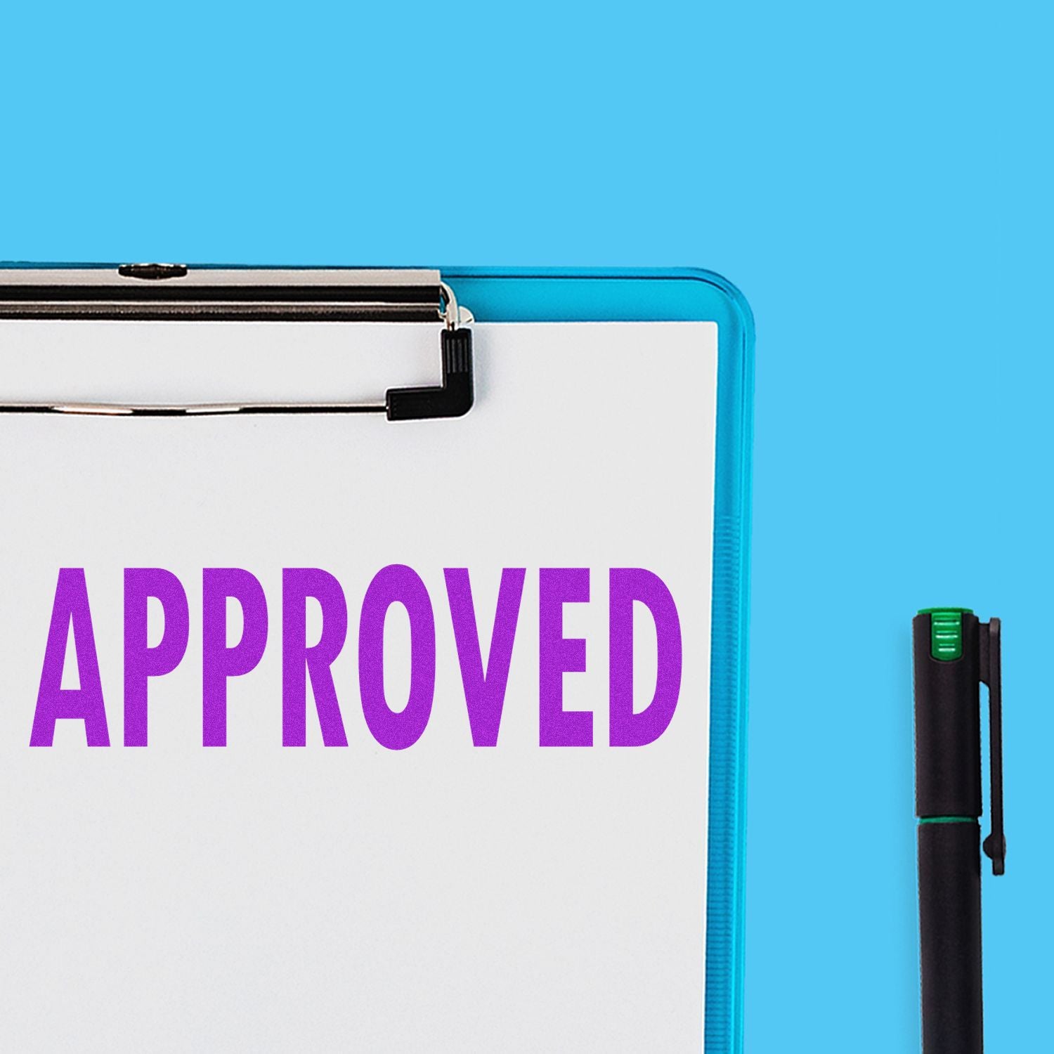 A clipboard with a paper stamped APPROVED in purple ink using the Large Self Inking Approved Stamp, next to a black pen on a blue background.