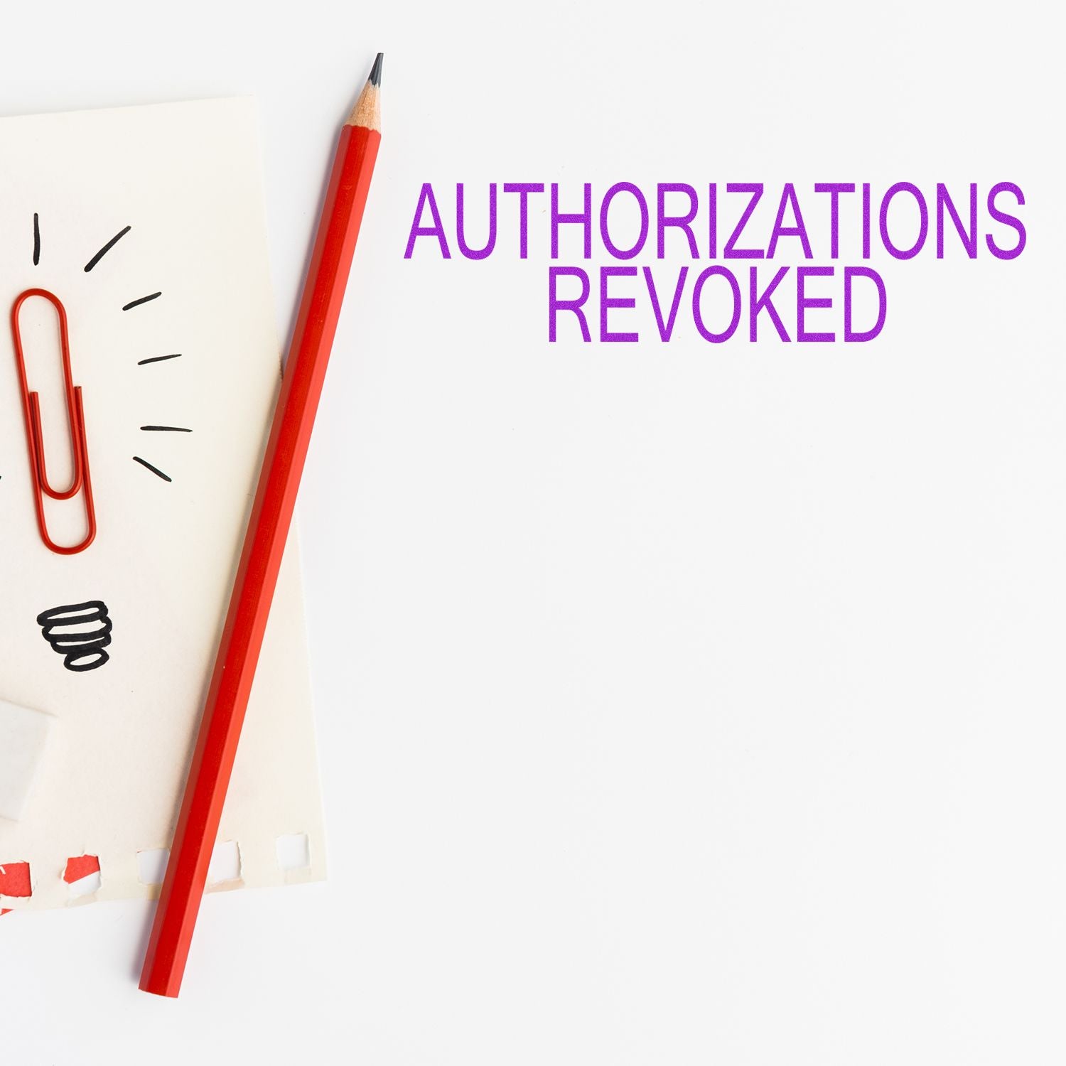 Authorizations Revoked rubber stamp next to a red pencil and paperclip on a white background.