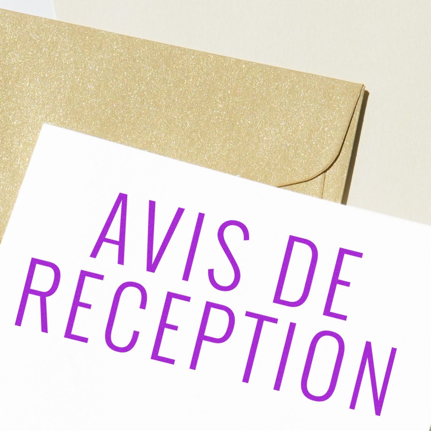 Close-up of an envelope and a document stamped with 'Avis De Reception' in purple ink, indicating receipt acknowledgment.